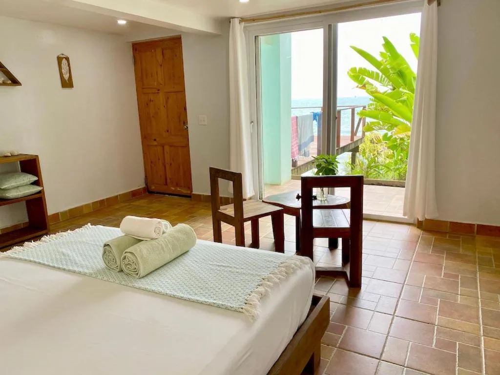 Bed in Bird Island Bungalows