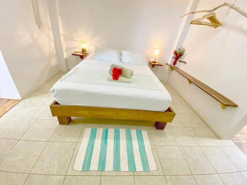 Bed in Bird Island Bungalows