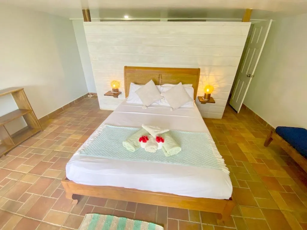 Bed in Bird Island Bungalows