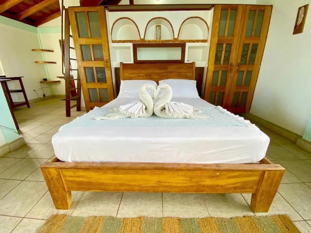Bed in Bird Island Bungalows