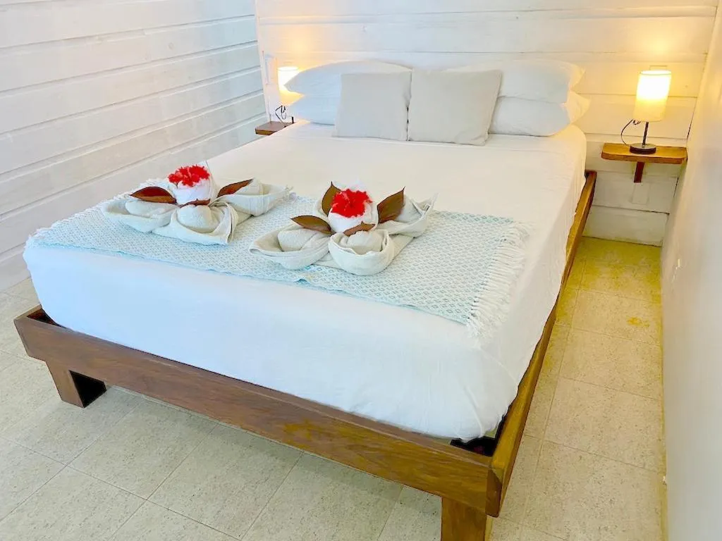 Bed in Bird Island Bungalows