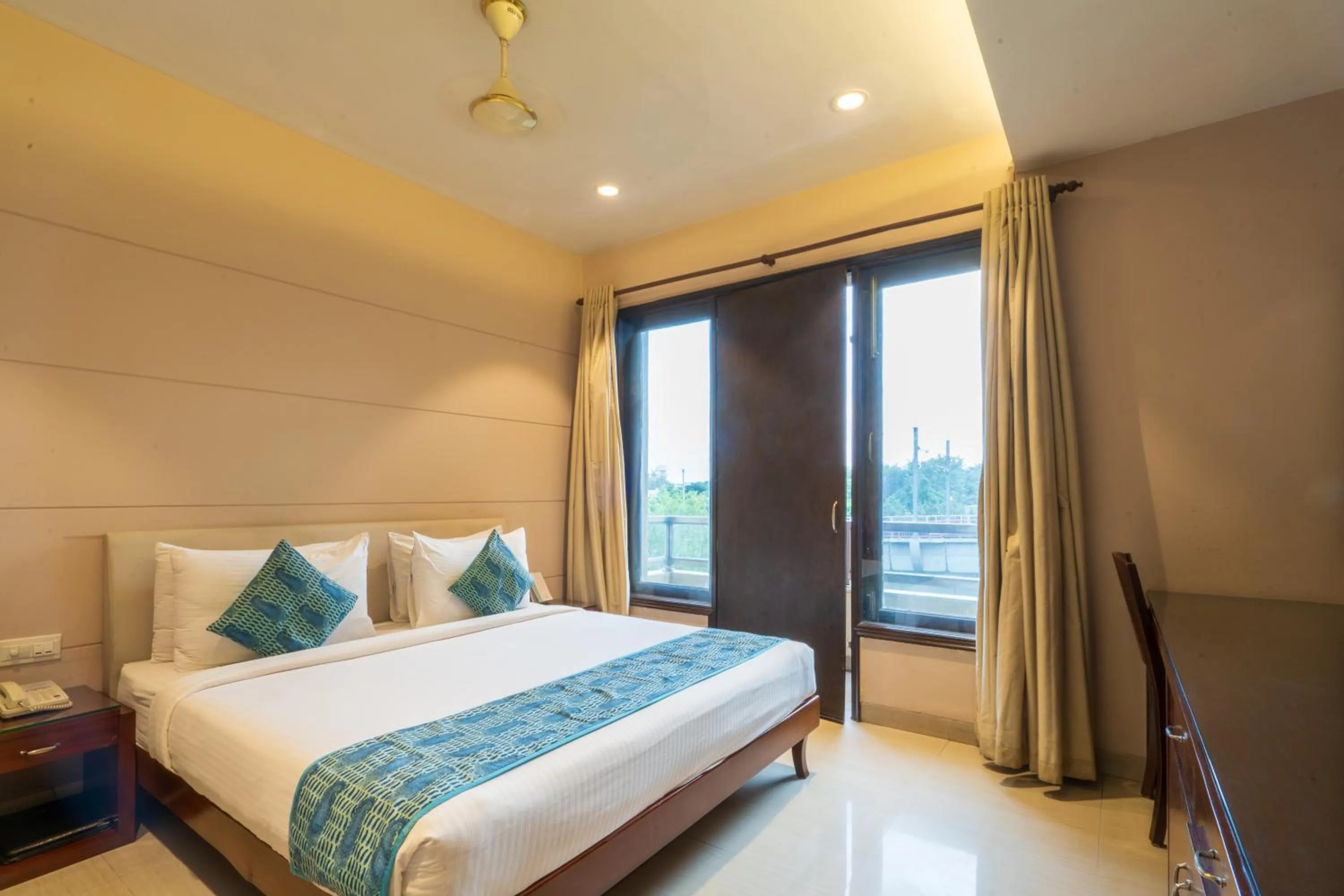 Photo of the whole room, Bed in Cosy Grand, Chanakyapuri by The Cosy Hotels