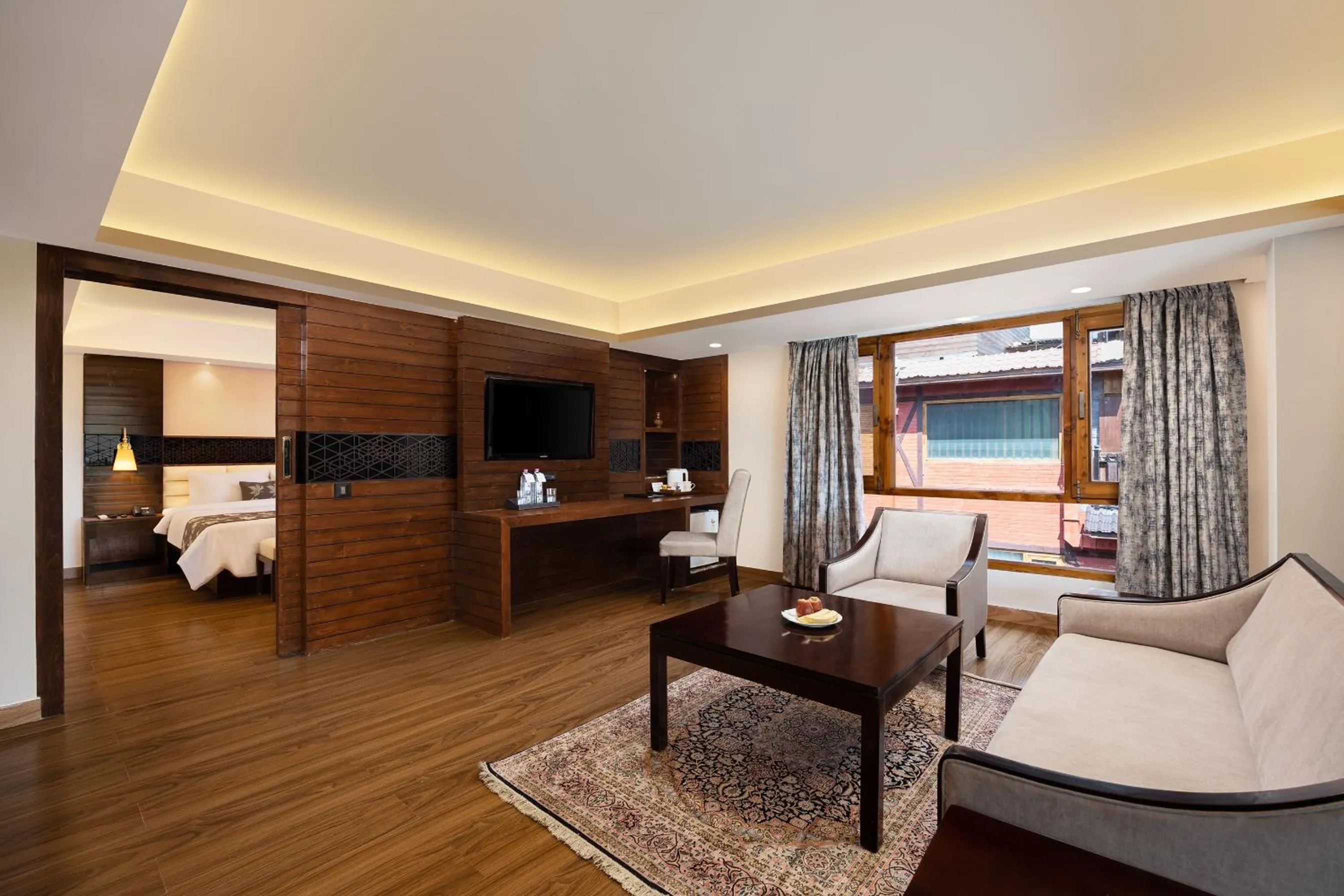 Seating area, Bed in Golden Tulip Srinagar