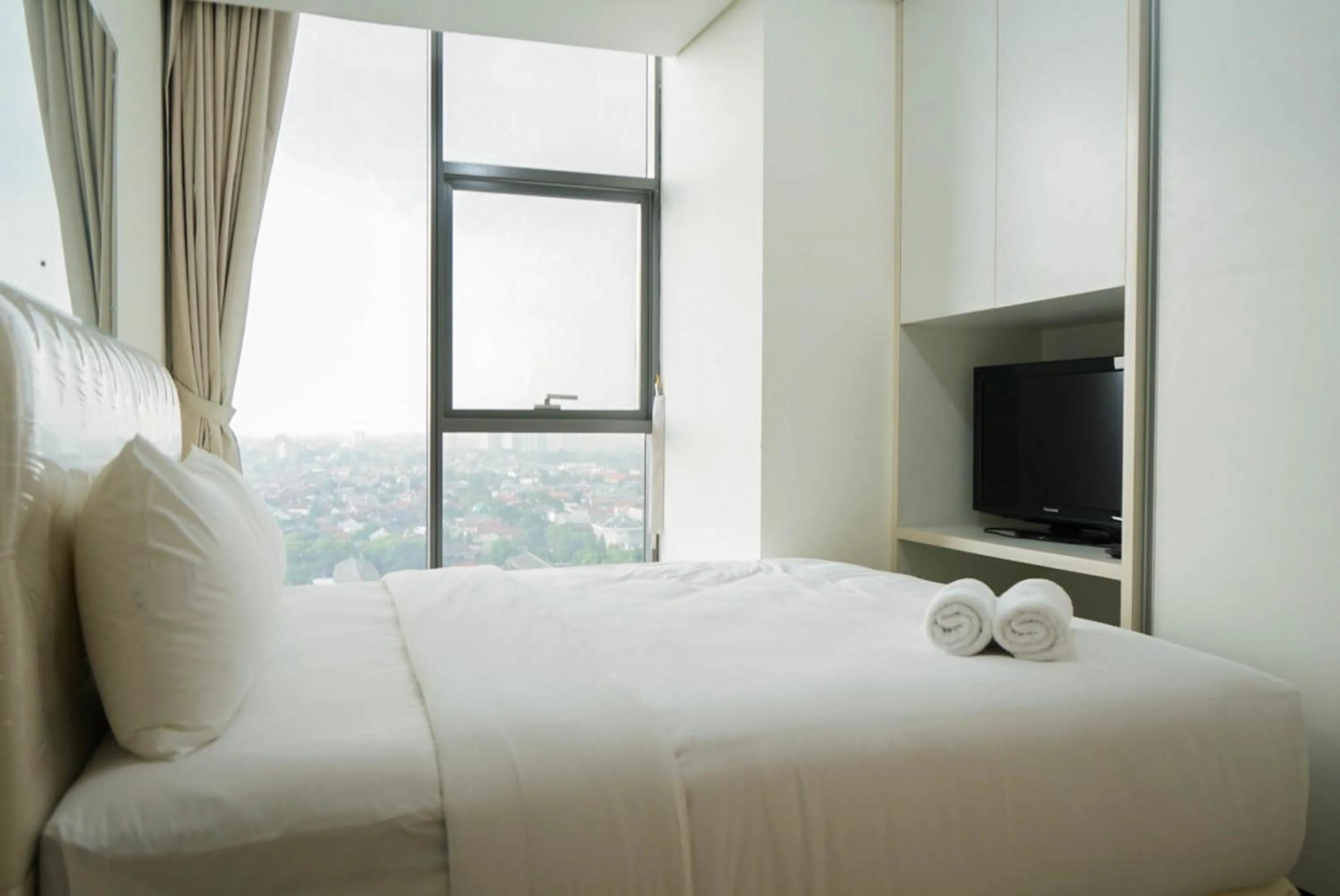 Bed in 2BR with Study Room at L'Avenue Apartment By Travelio