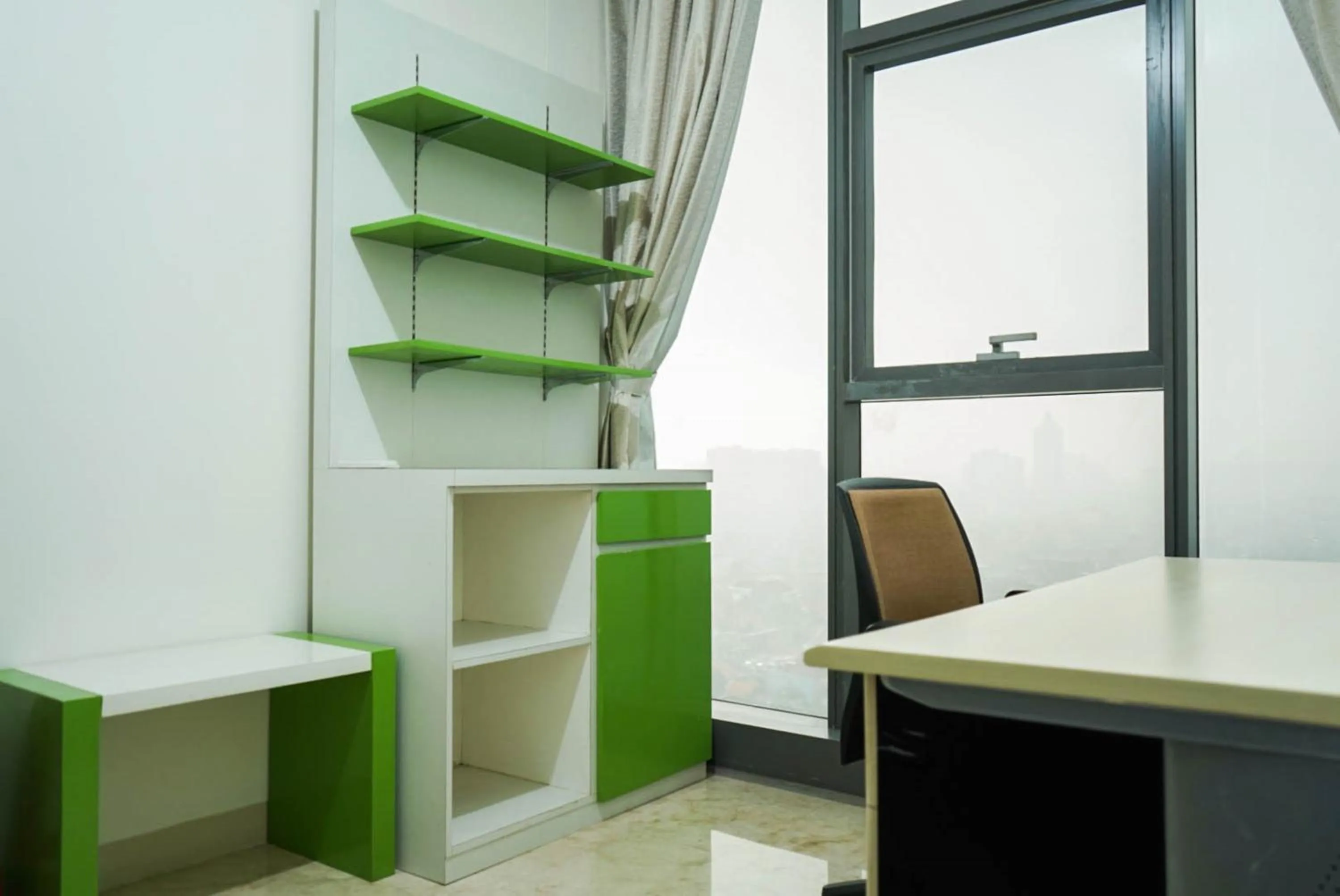 Seating area in 2BR with Study Room at L'Avenue Apartment By Travelio