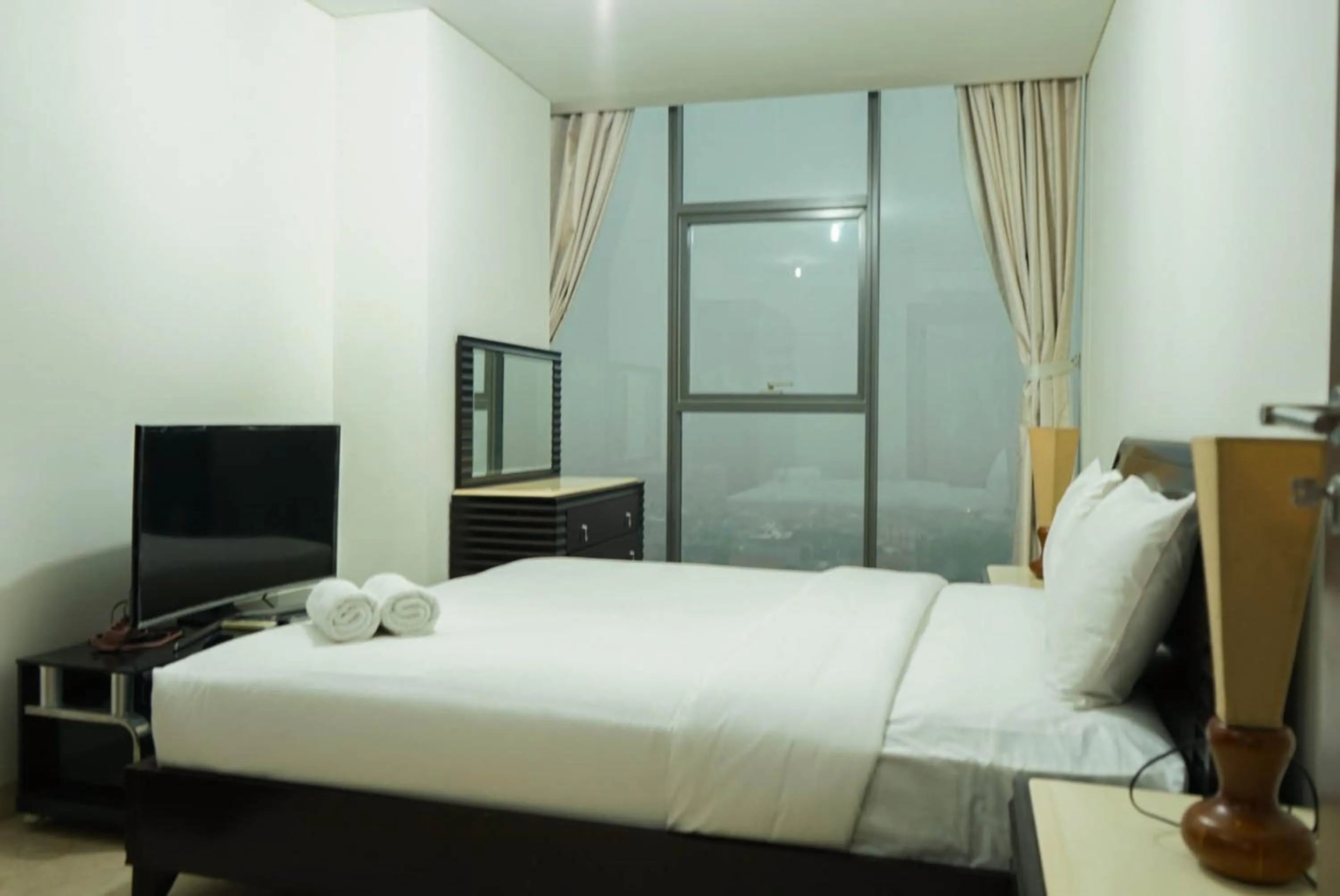Bed in 2BR with Study Room at L'Avenue Apartment By Travelio