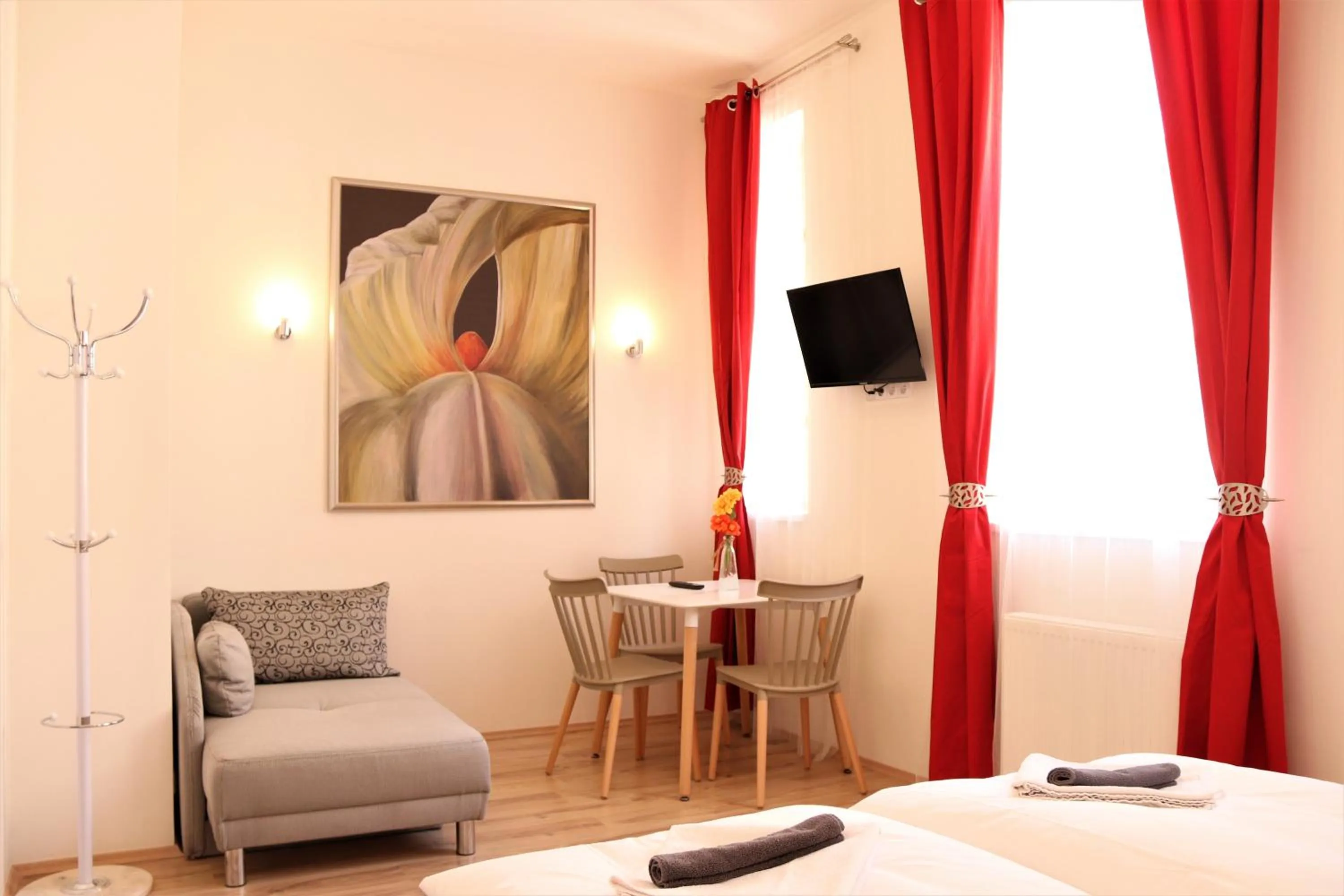 Seating area, Bed in Flowers apartments