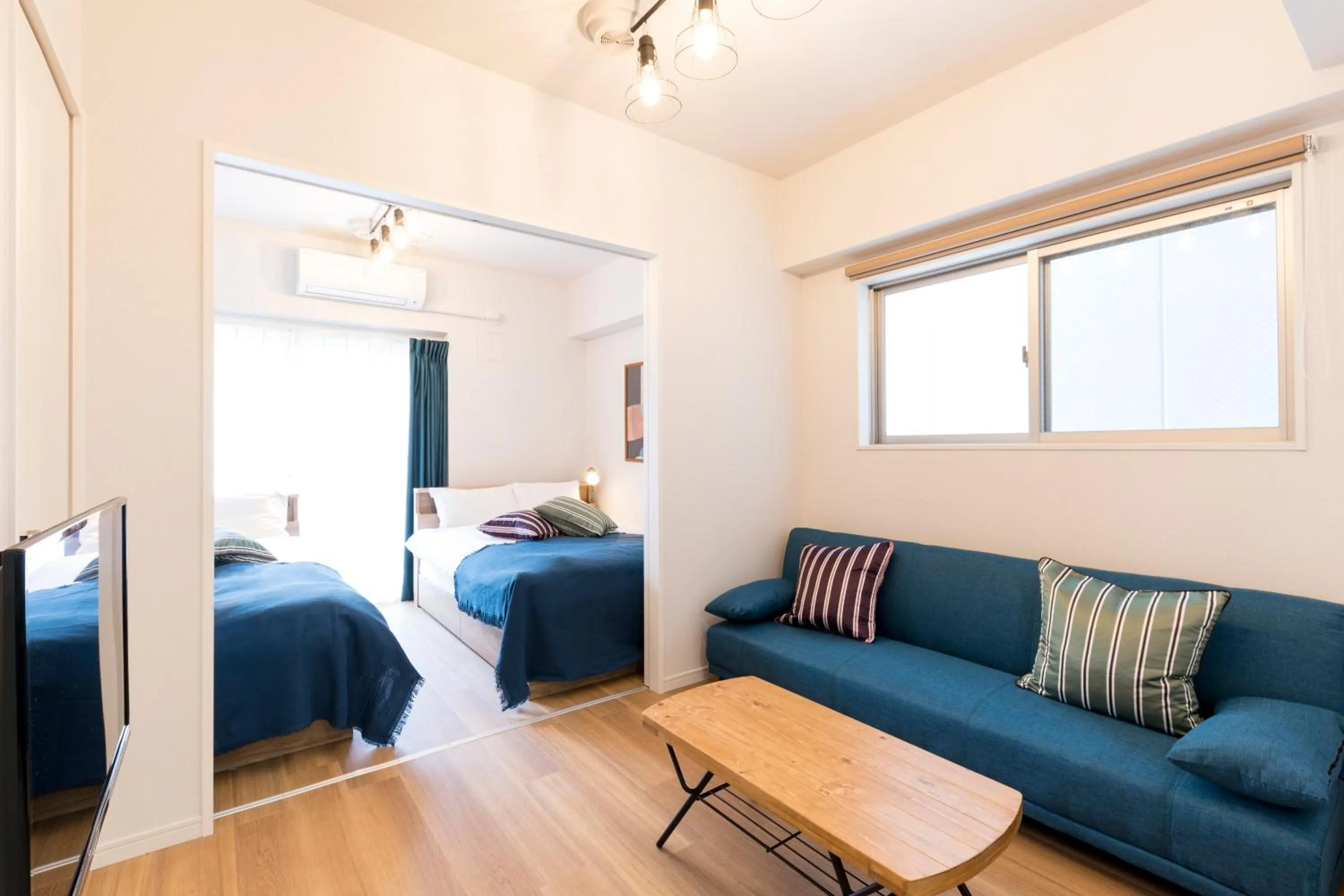 Living room, Bed in SG Residence Inn Hakataekiminami