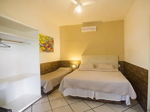 Bed in Pousada Três Pescadores