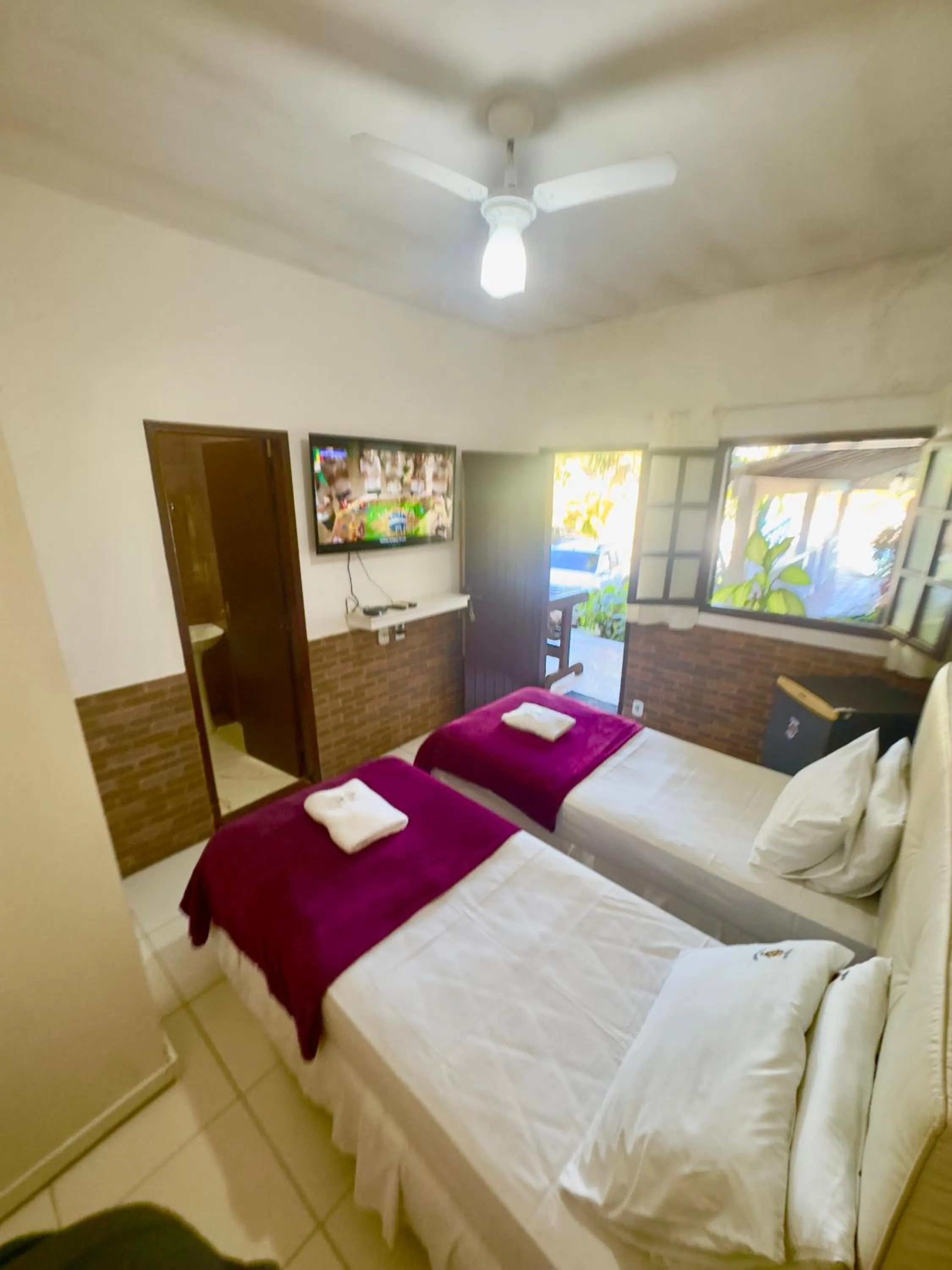 Bed in Pousada Três Pescadores