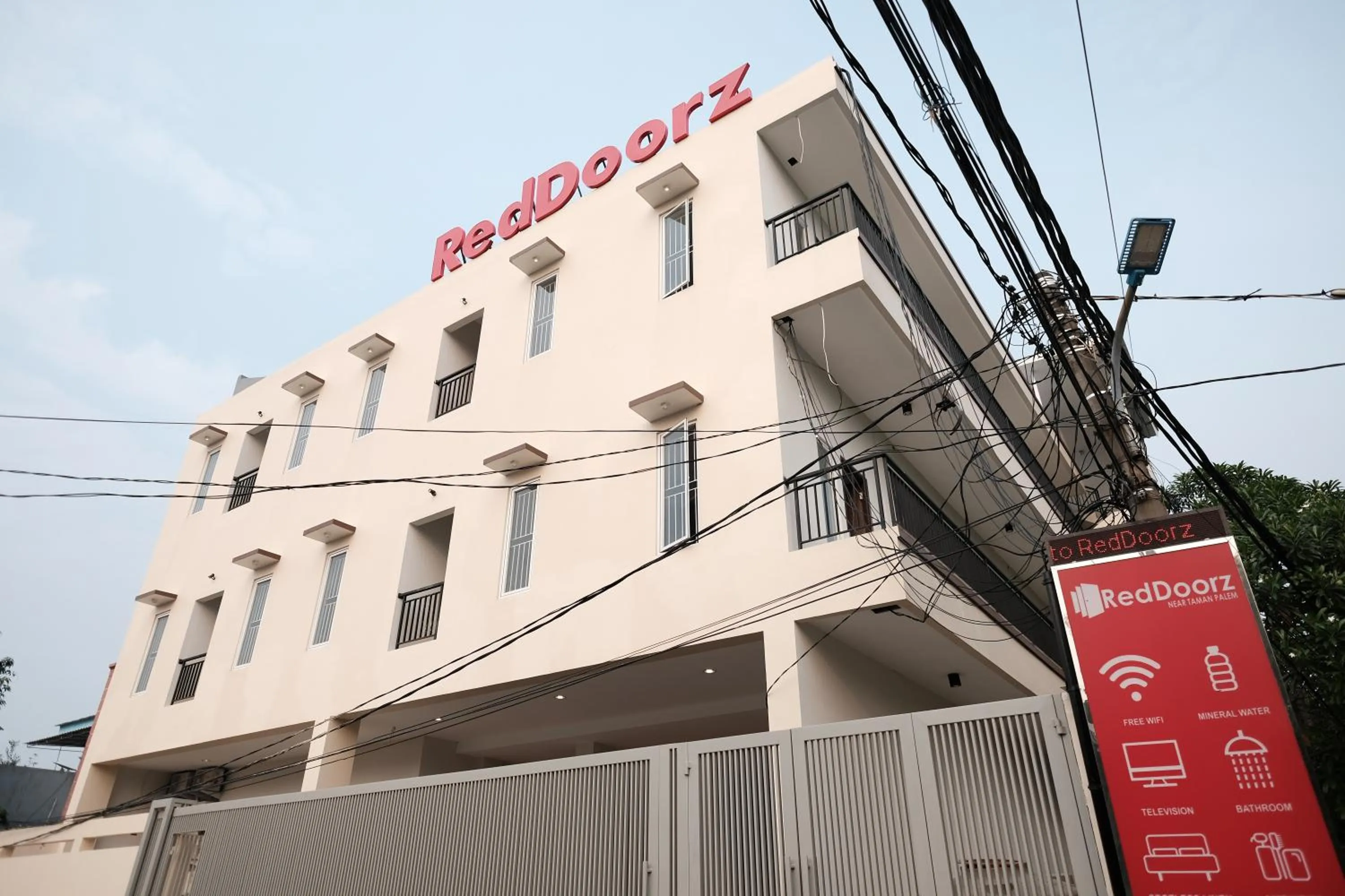 Property logo or sign in RedDoorz near Taman Palem