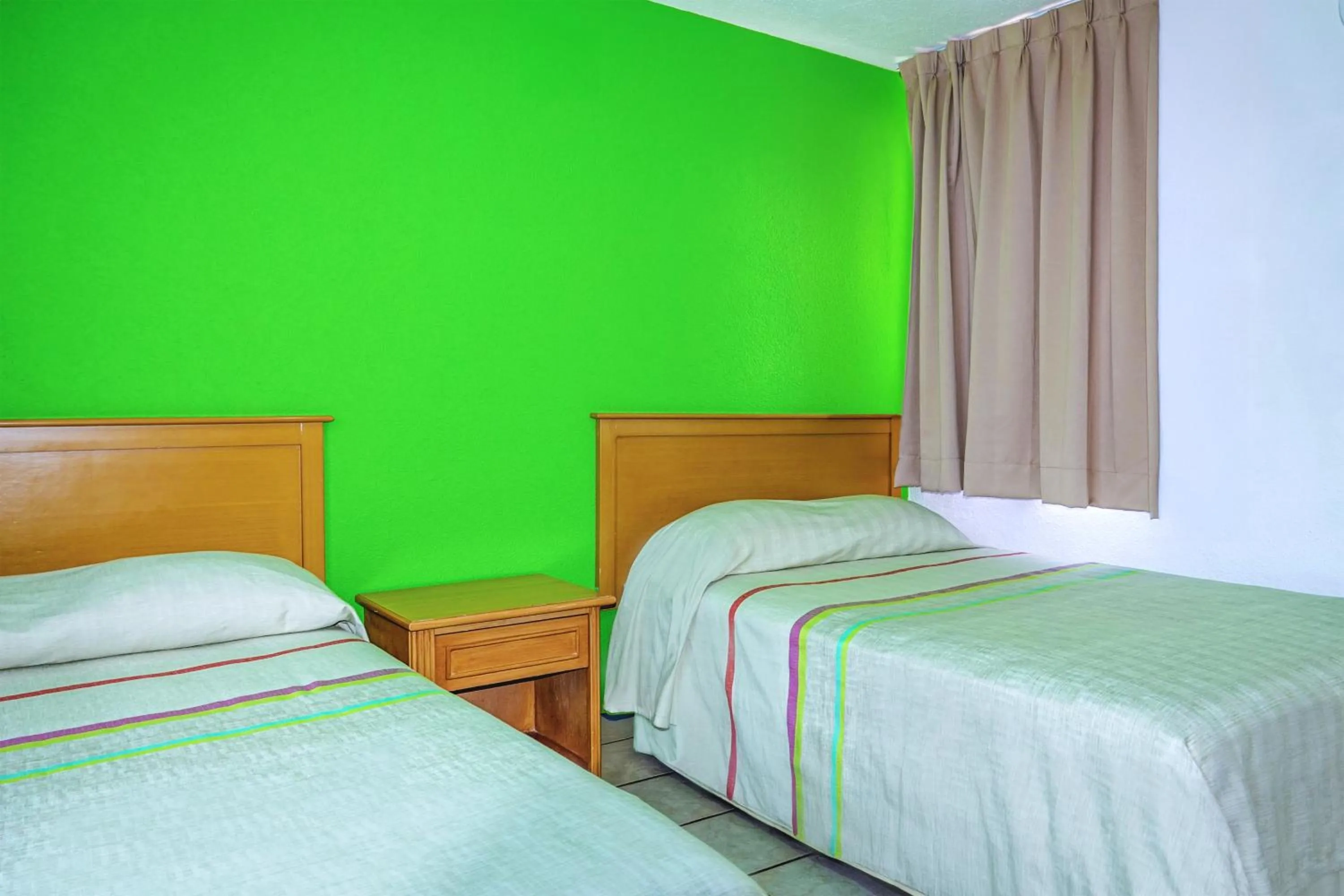 Bed in Sunrock Hotel & Suites