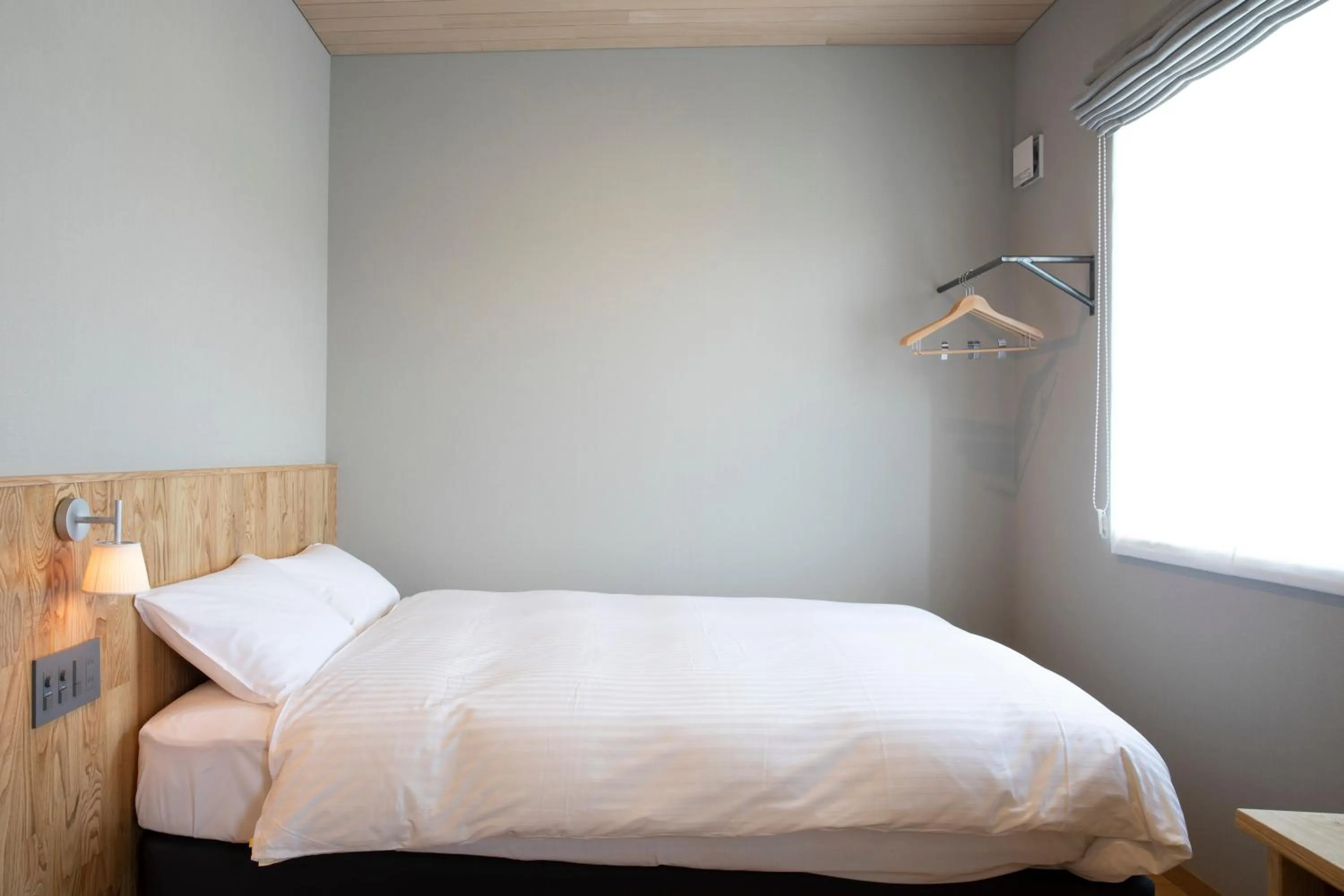 Bed in MASCOS HOTEL Masuda Onsen