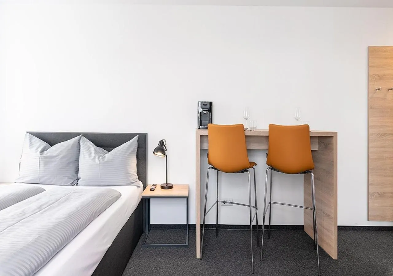Seating area, Bed in Apartimo Landshut