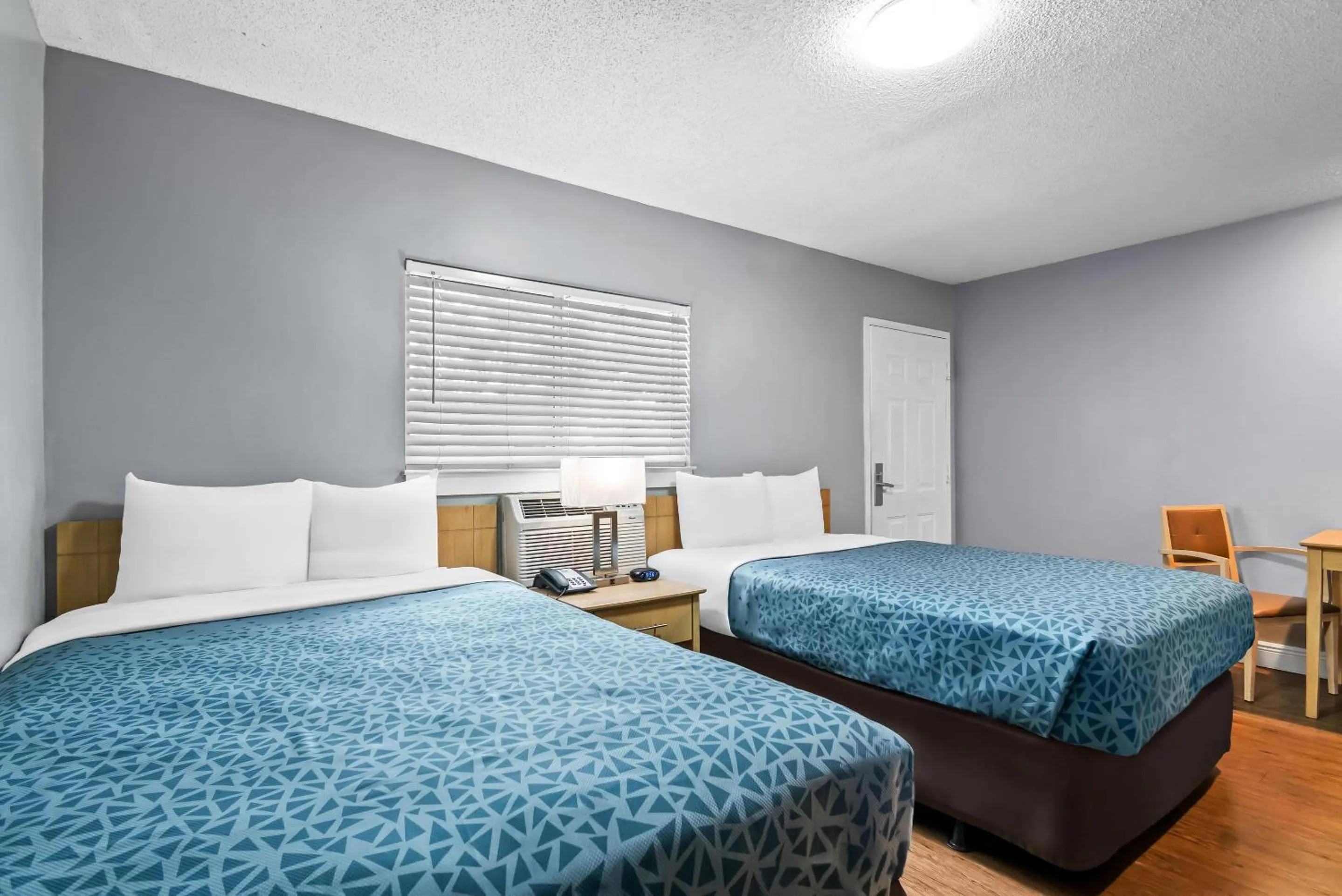 Bedroom, Bed in Suburban Studios Stuart near Federal Hwy 1