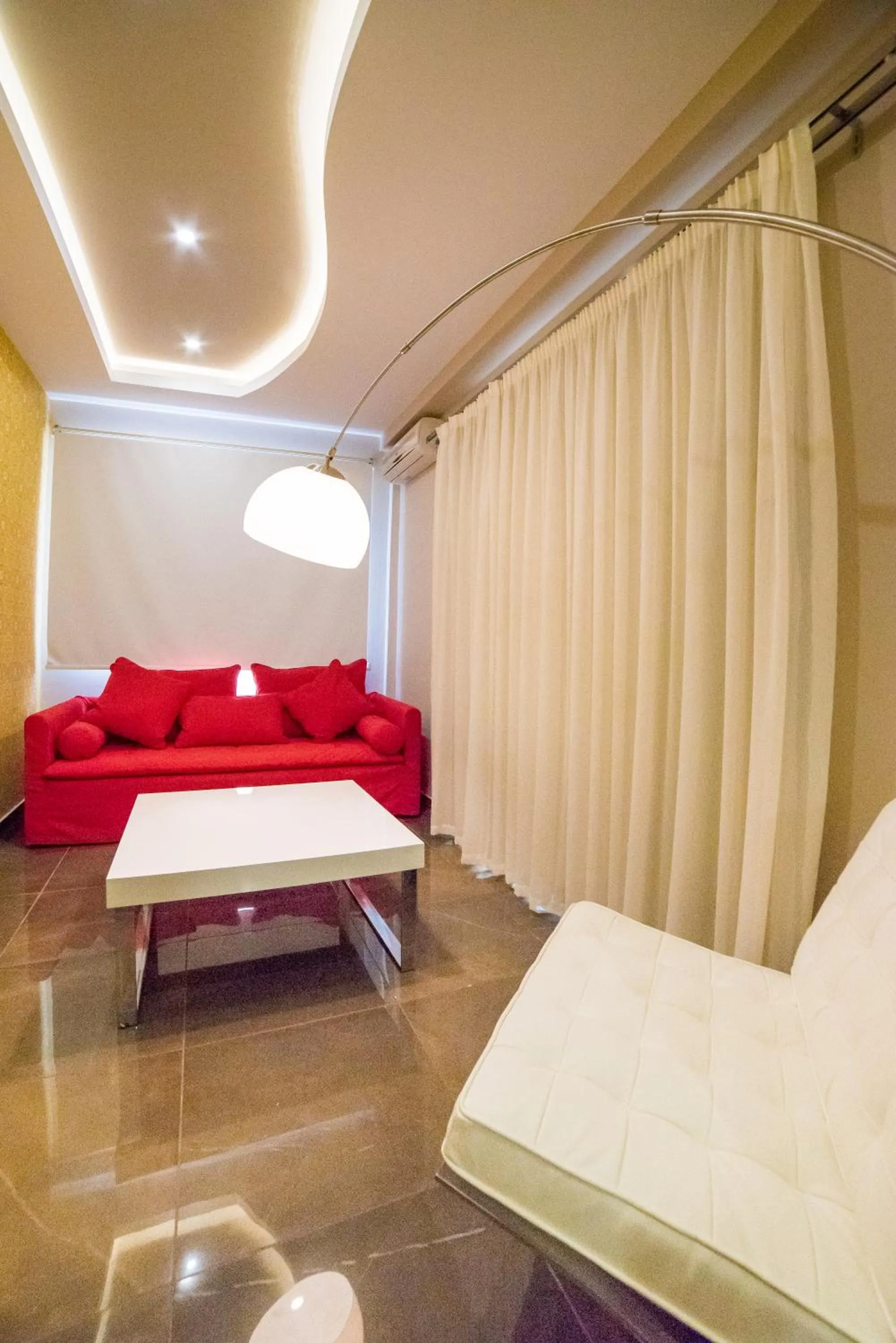 Living room, Bed in Koukounaria Hotel & Suites