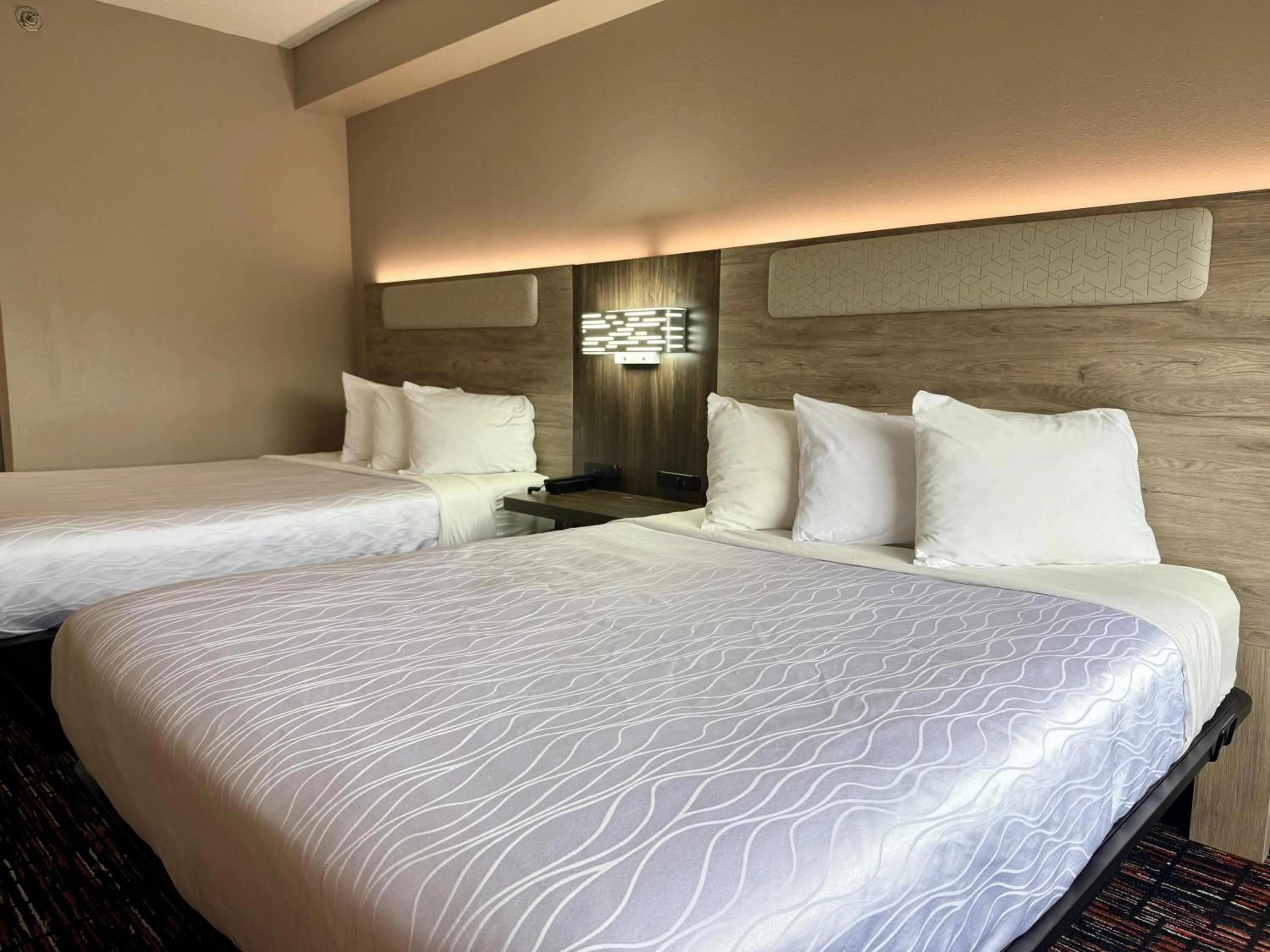 Bed in Reston Inn & Suites