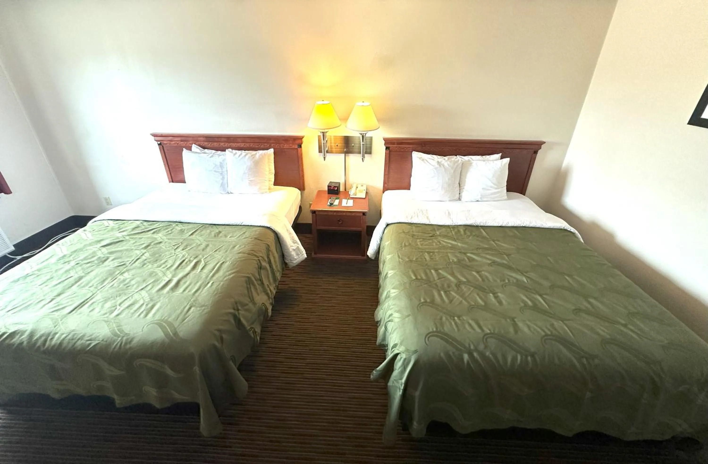 Bed in Sunflower Inn & Suites