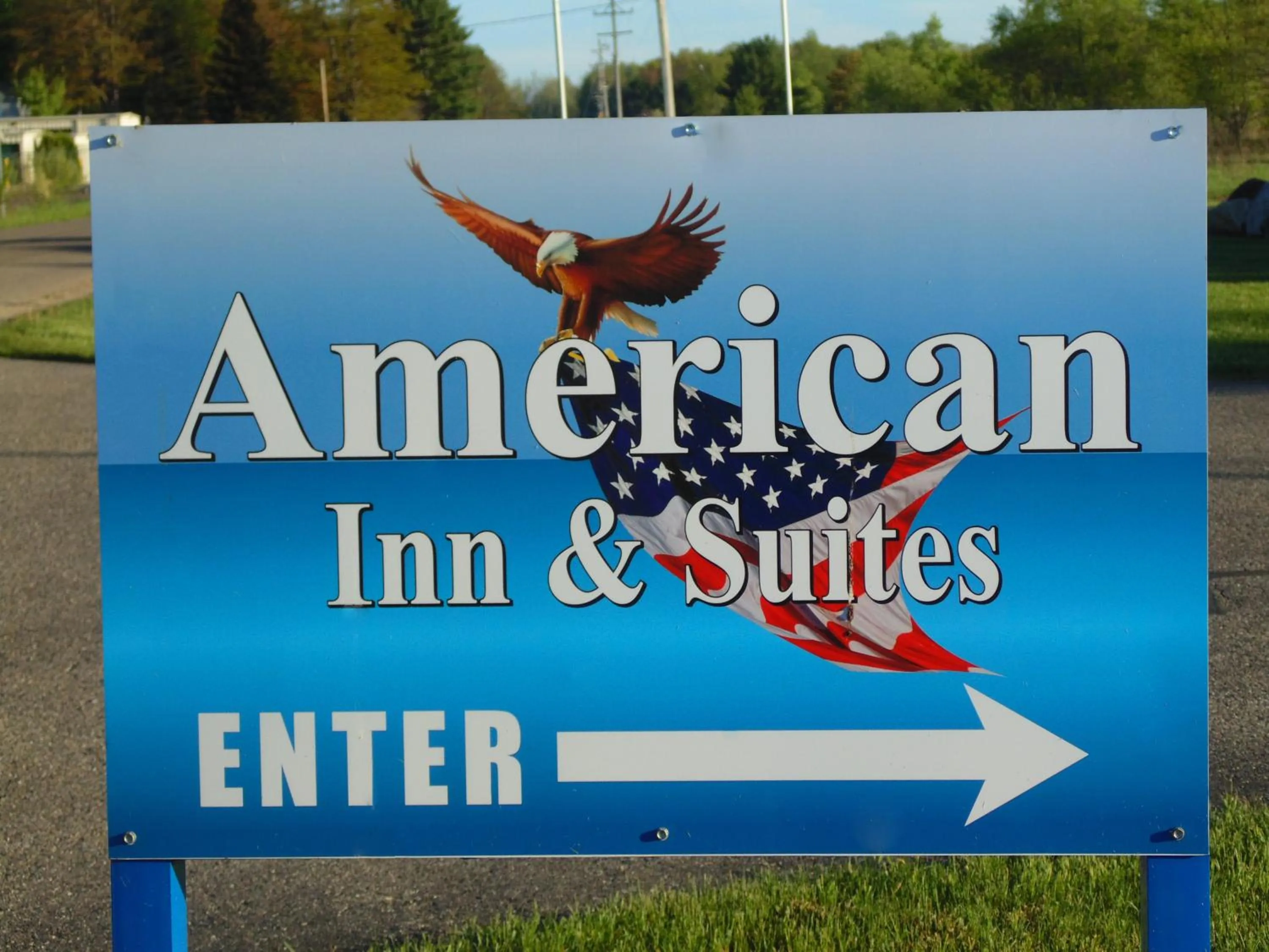 Property logo or sign in American Inn and Suites Houghton Lake