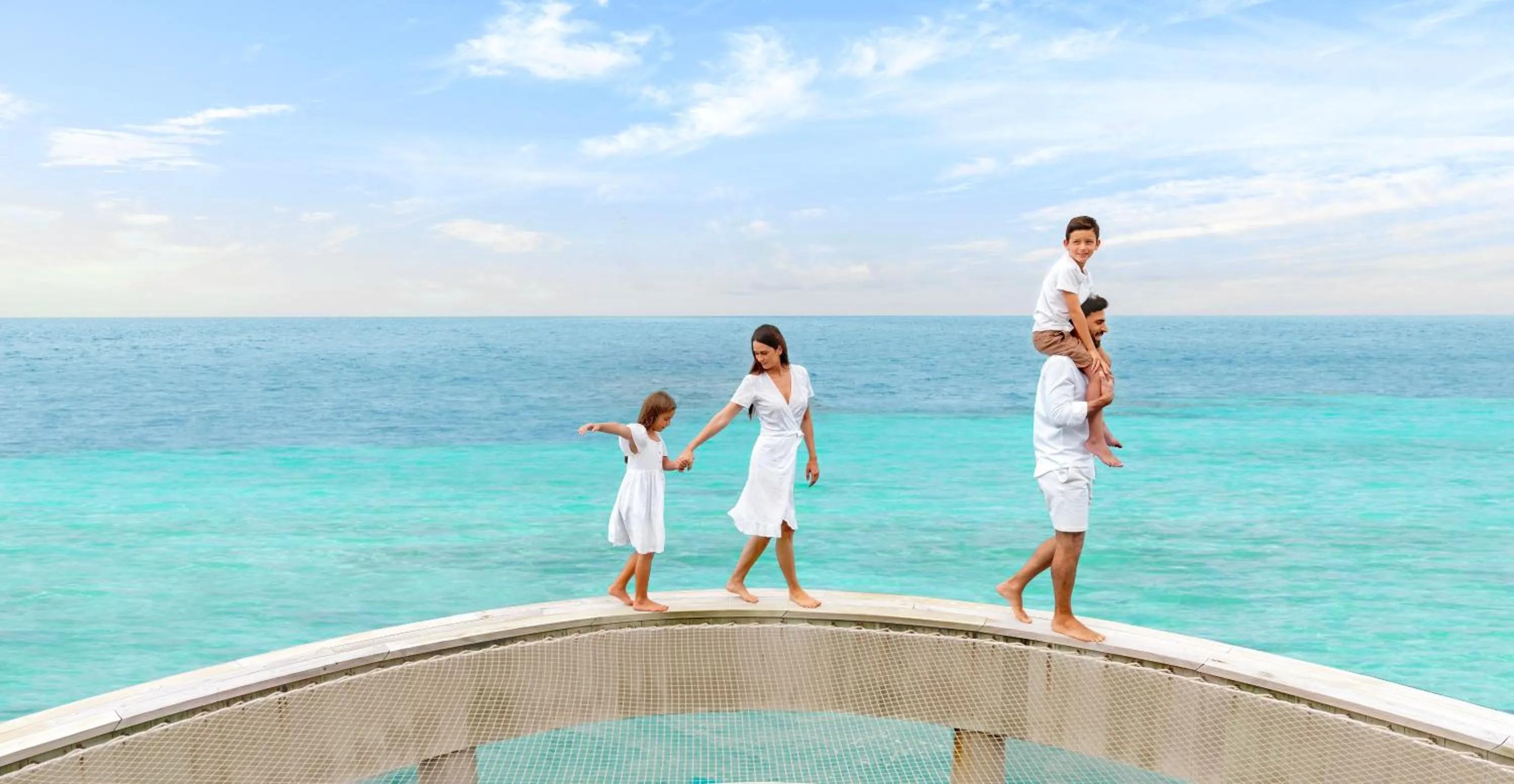 group of guests in Intercontinental Maldives Maamunagau Resort with Club benefits by IHG