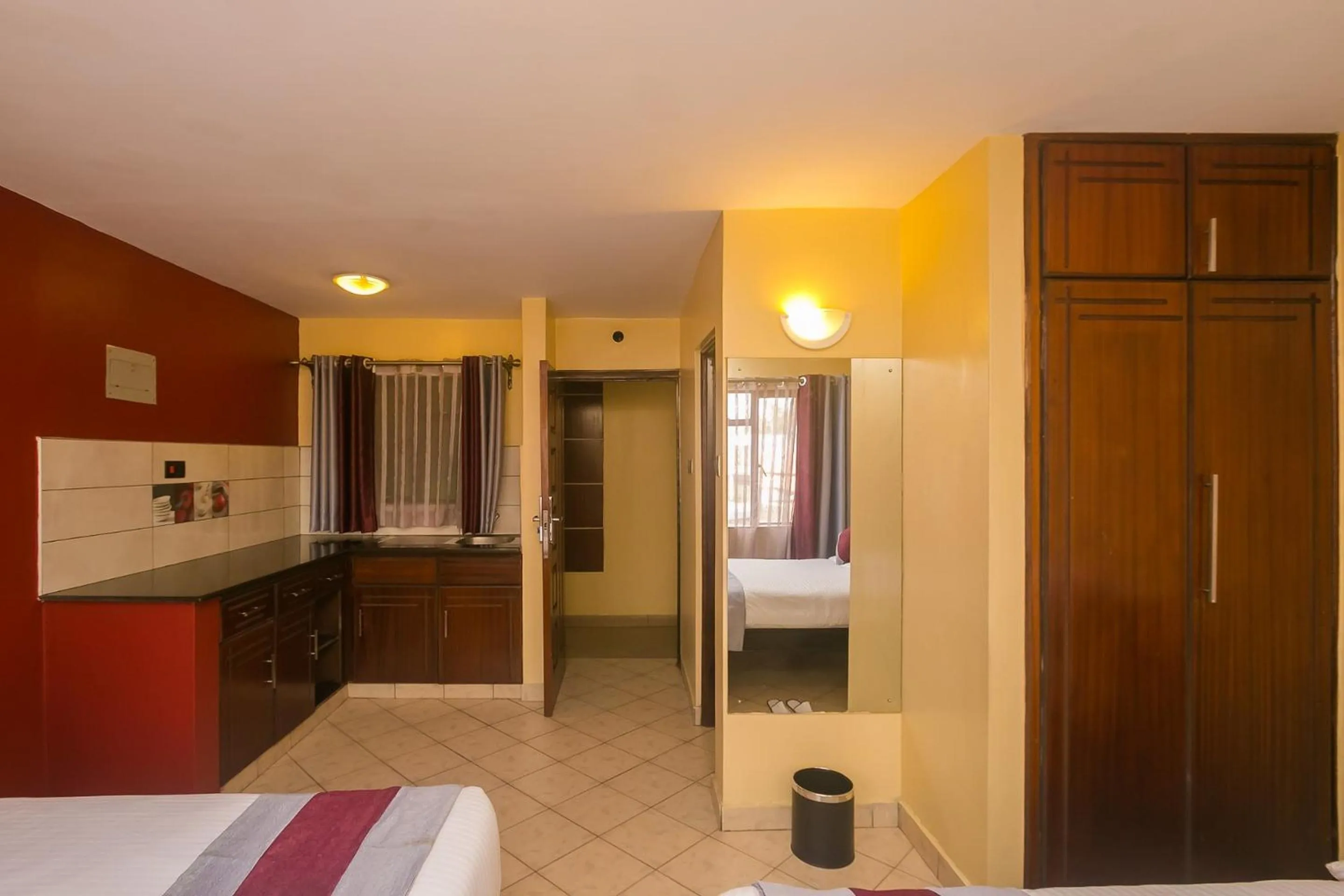 Kitchen or kitchenette, Bed in Plus254 Hotel