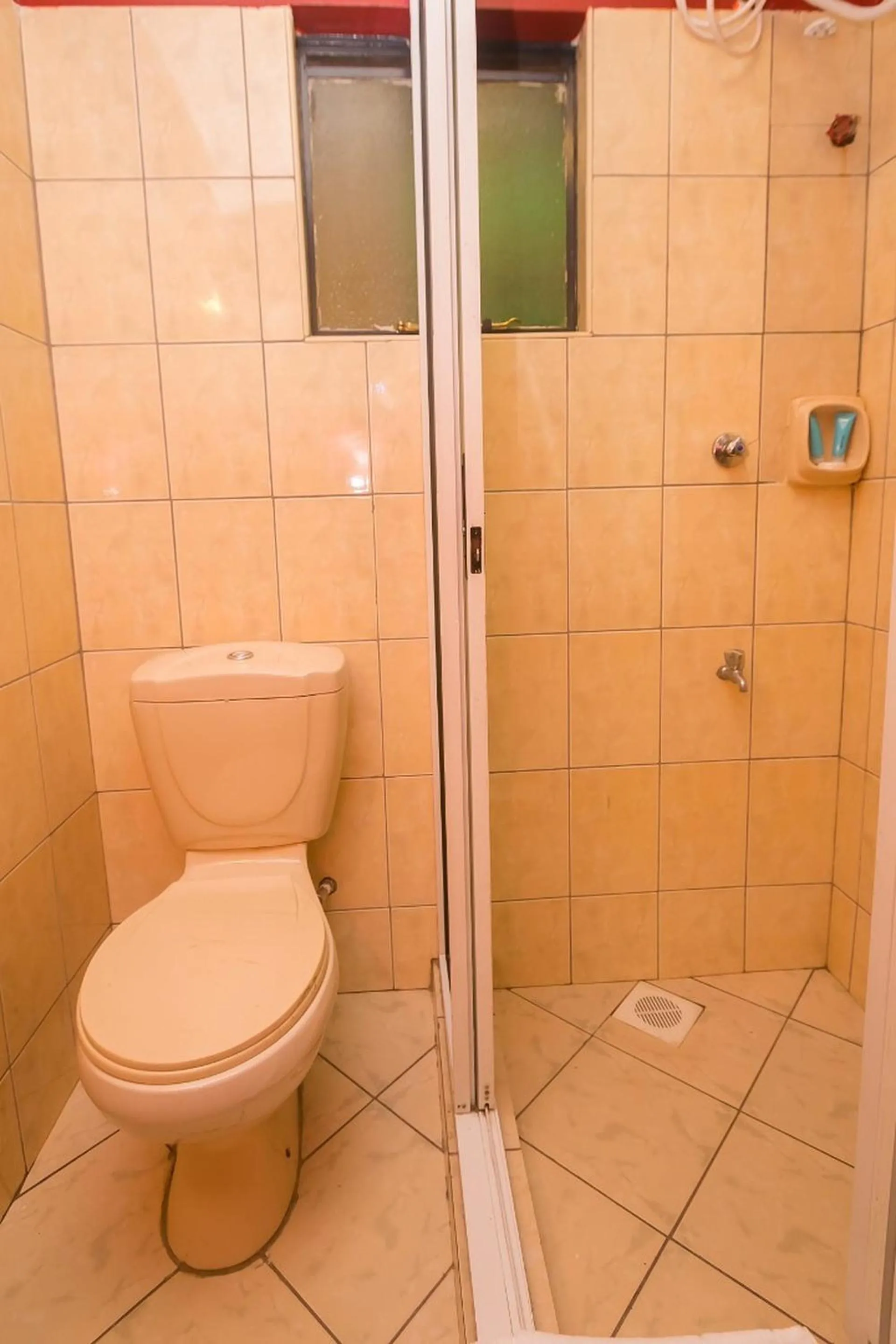 Toilet in Plus254 Hotel