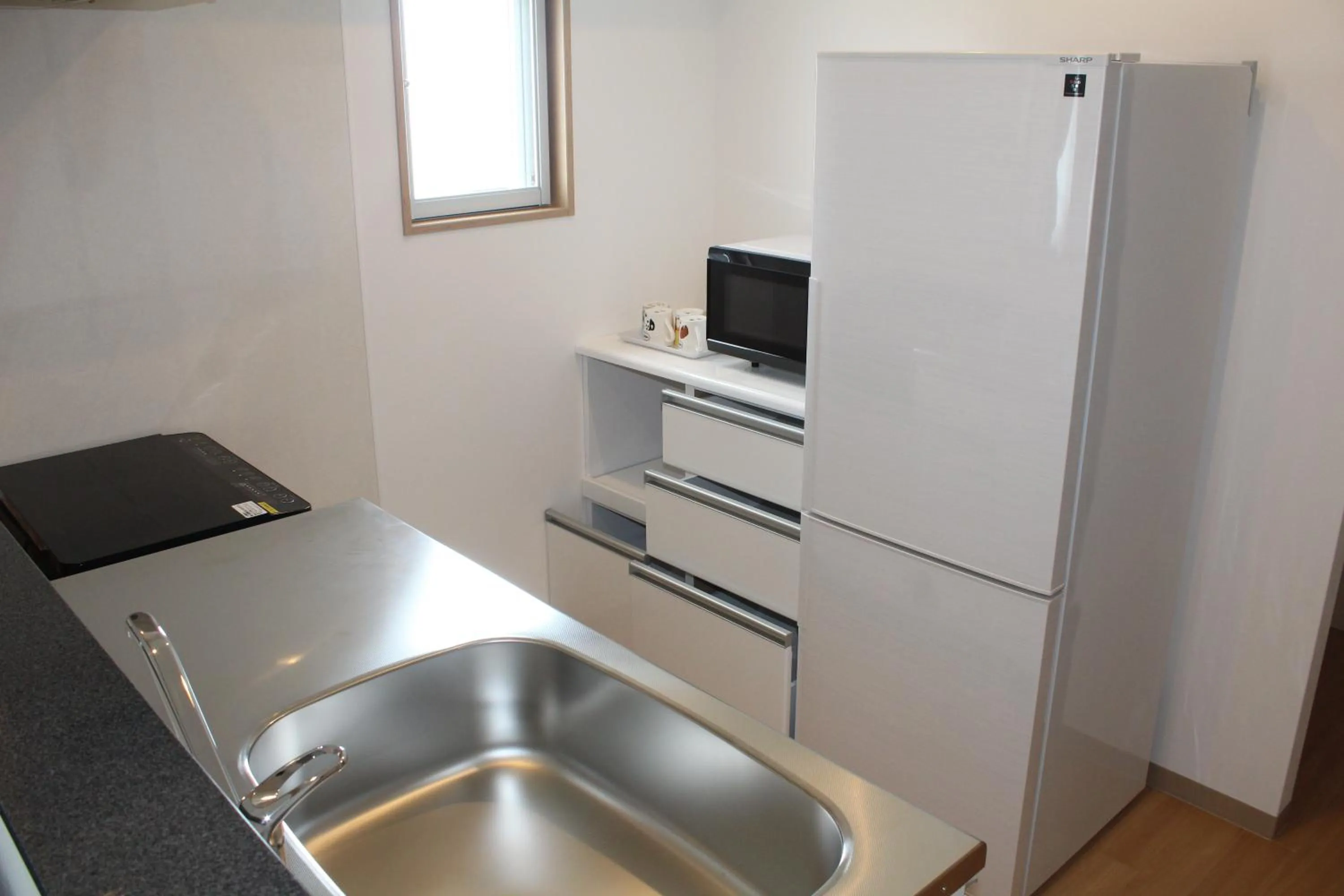 Kitchen or kitchenette in M´s Stay Okinawa