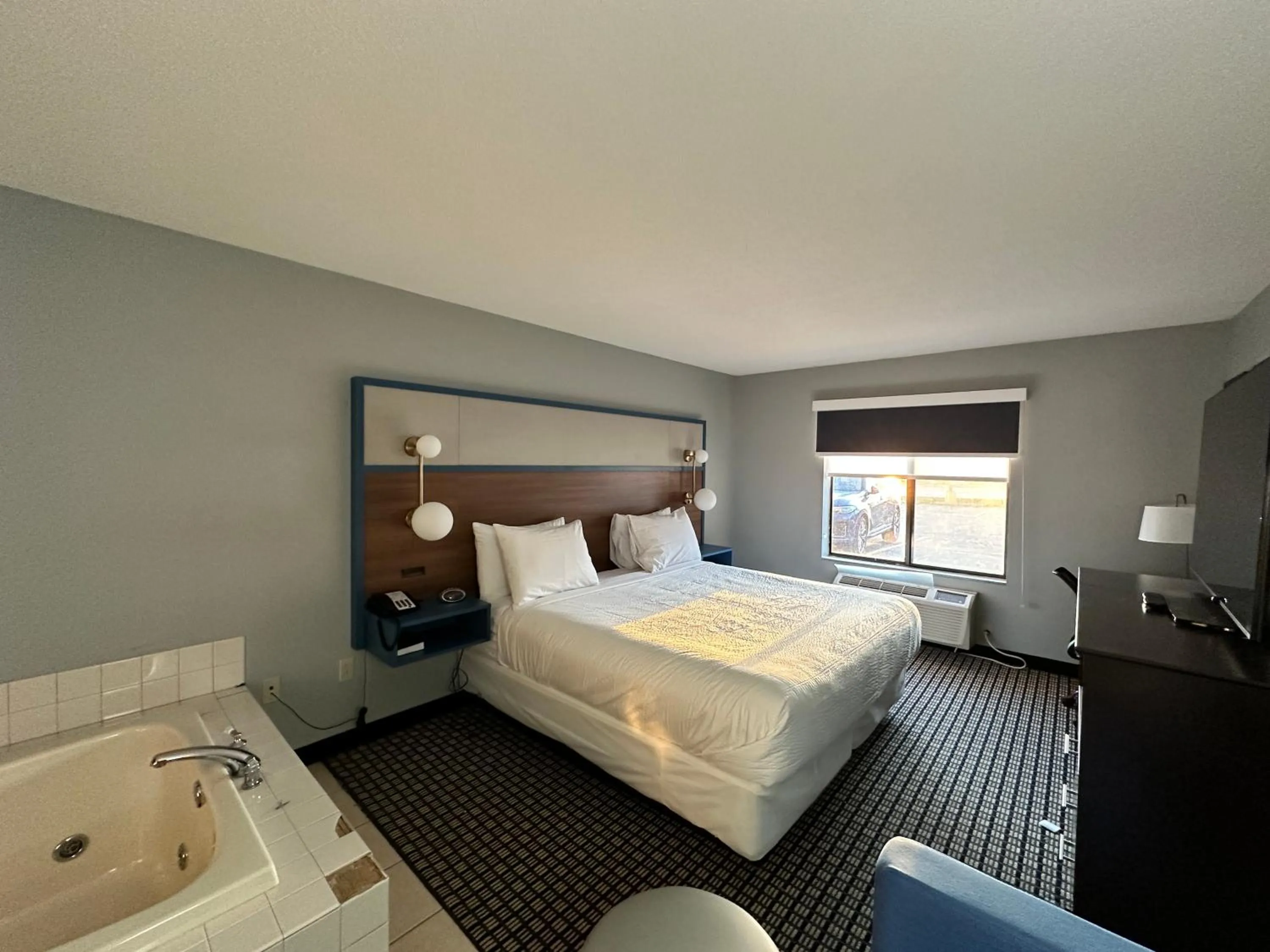 Bed in AmericInn by Wyndham Reedsburg
