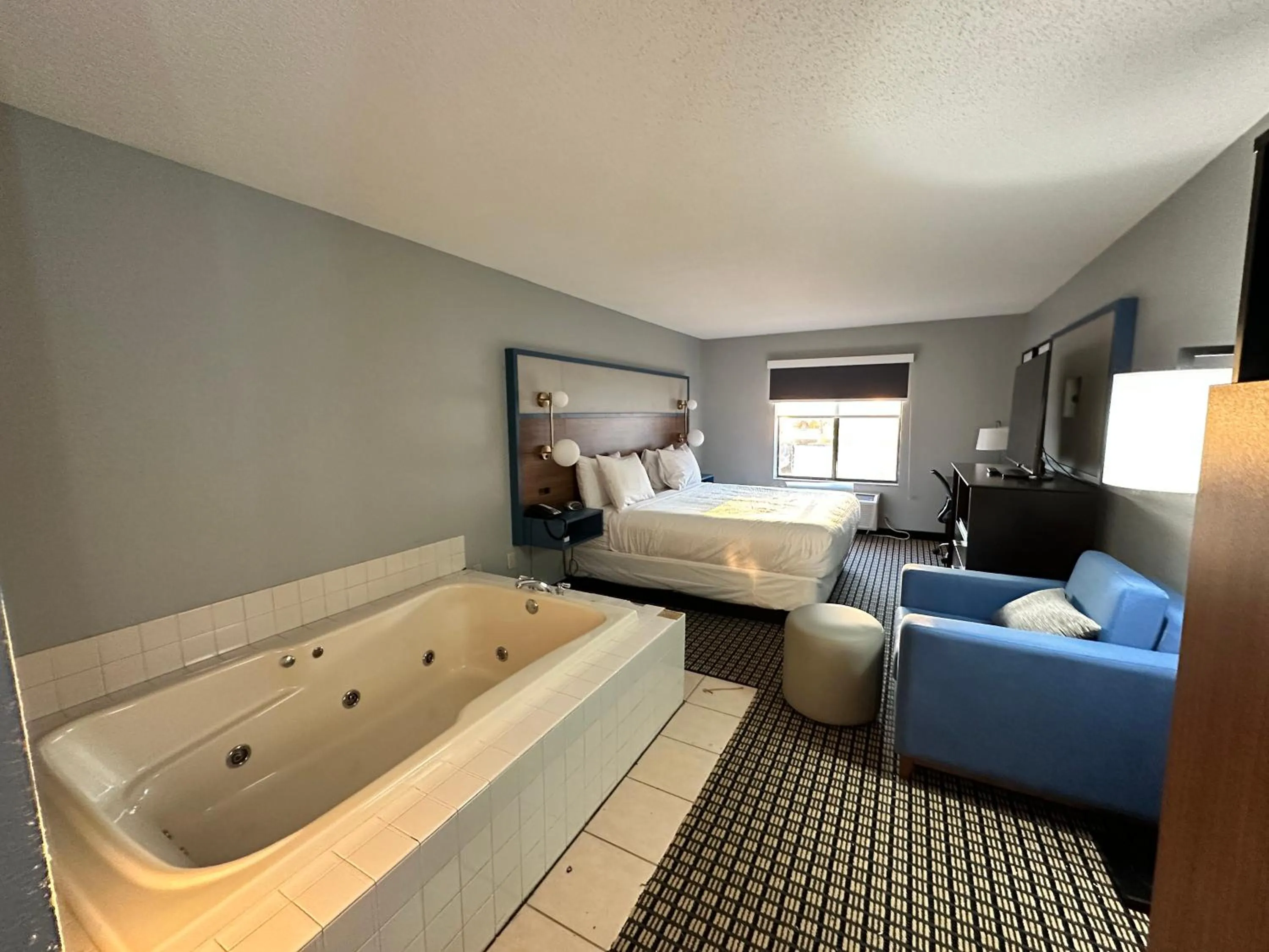 Bed in AmericInn by Wyndham Reedsburg