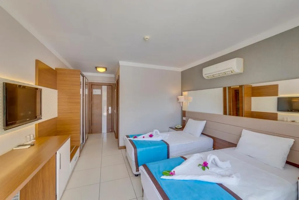 Communal lounge/ TV room, Bed in Marcan Resort Hotel