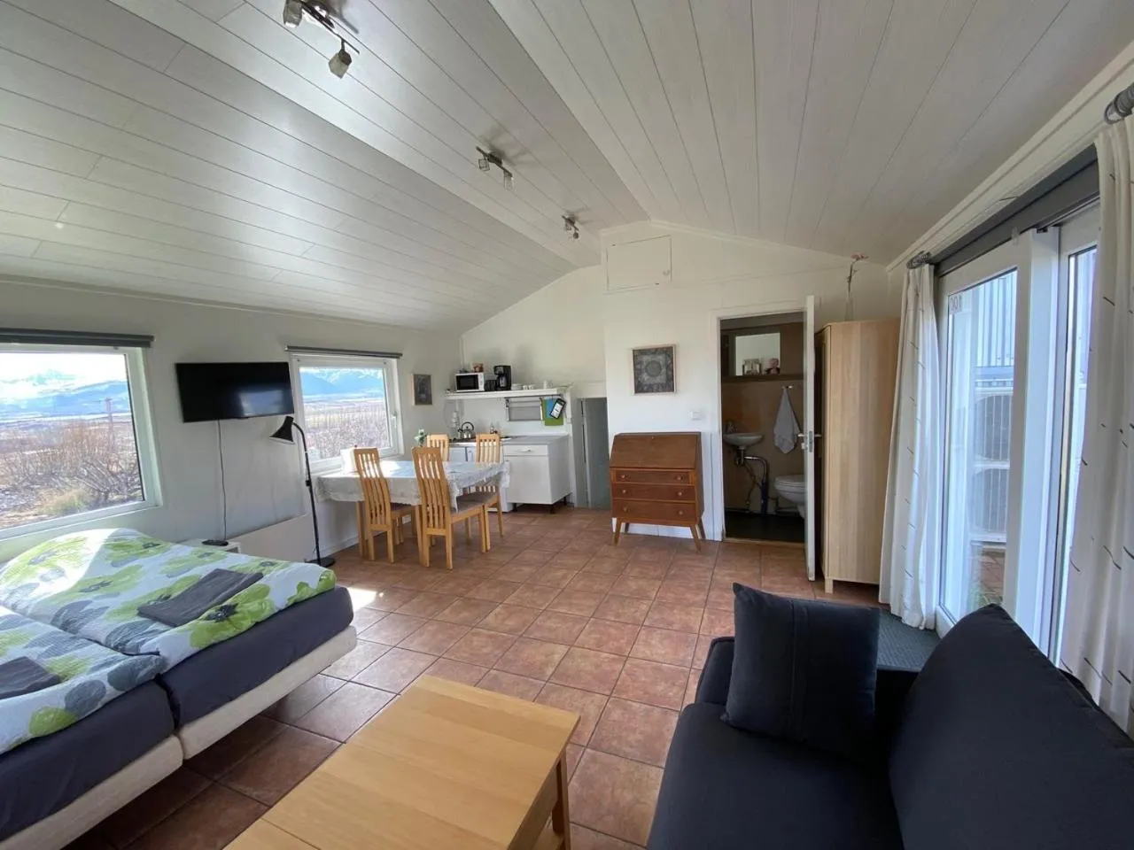 Communal lounge/ TV room, Bed in Lækjarkot Rooms and Cottages with Kitchen