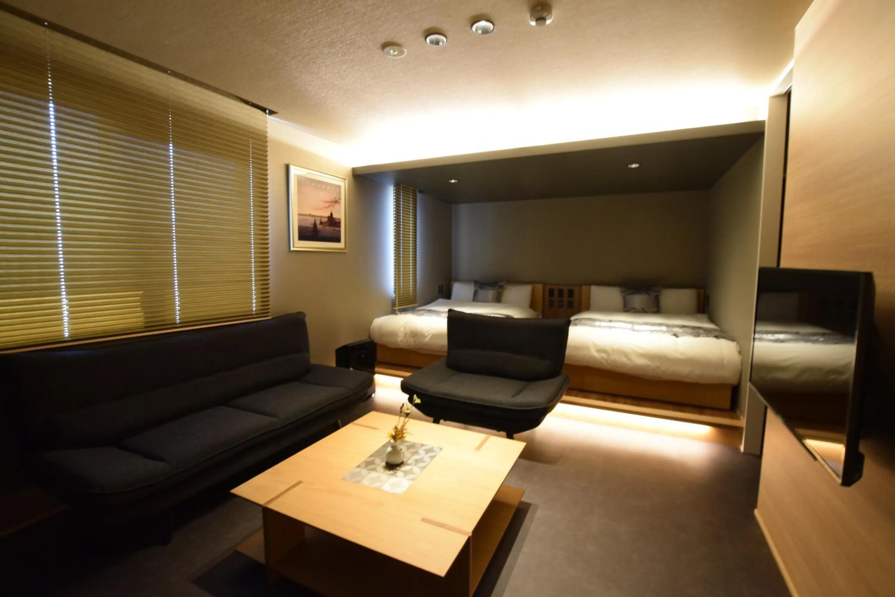 Photo of the whole room, Bed in GRAND BASE Beppu Ekimae