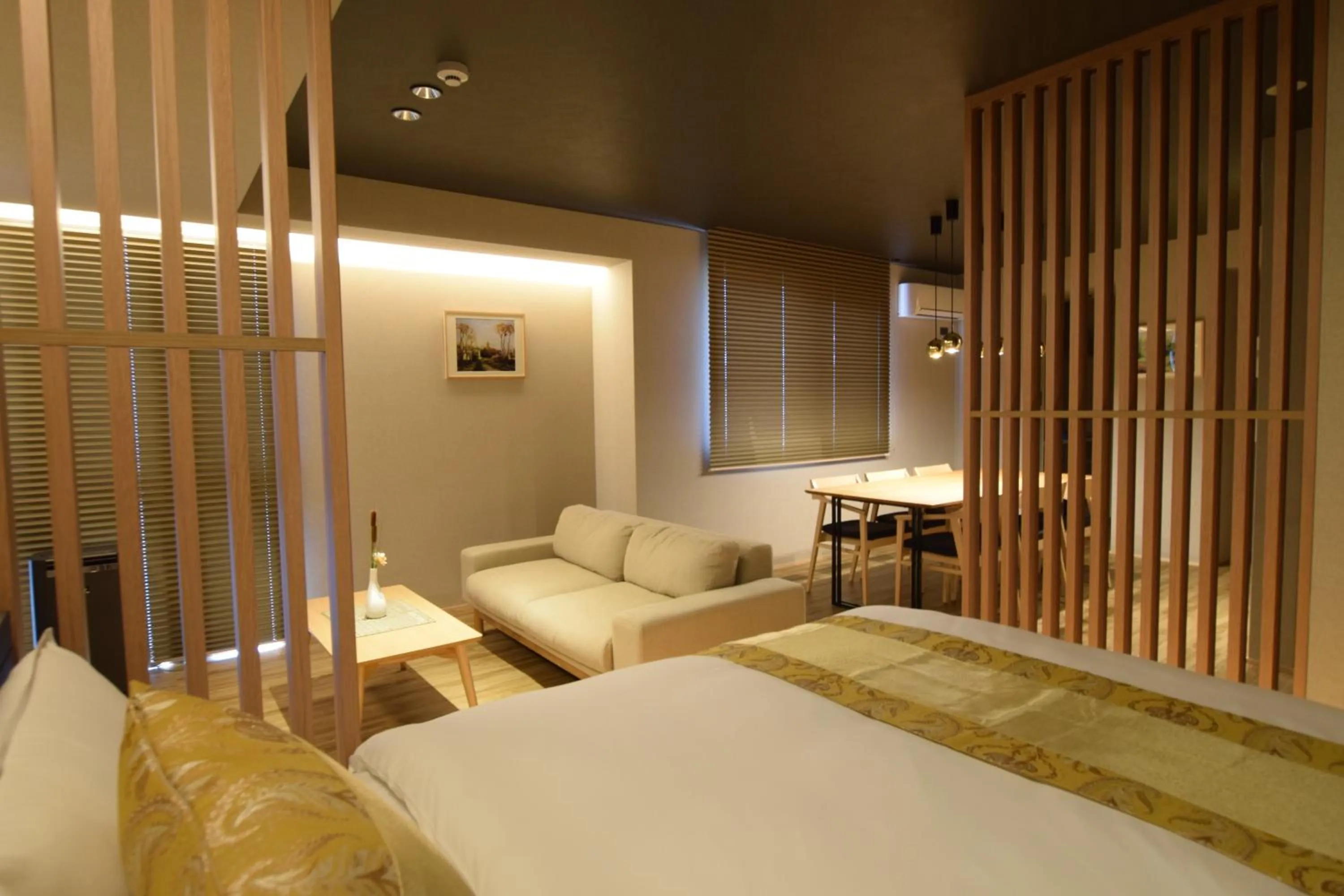 Photo of the whole room, Bed in GRAND BASE Beppu Ekimae