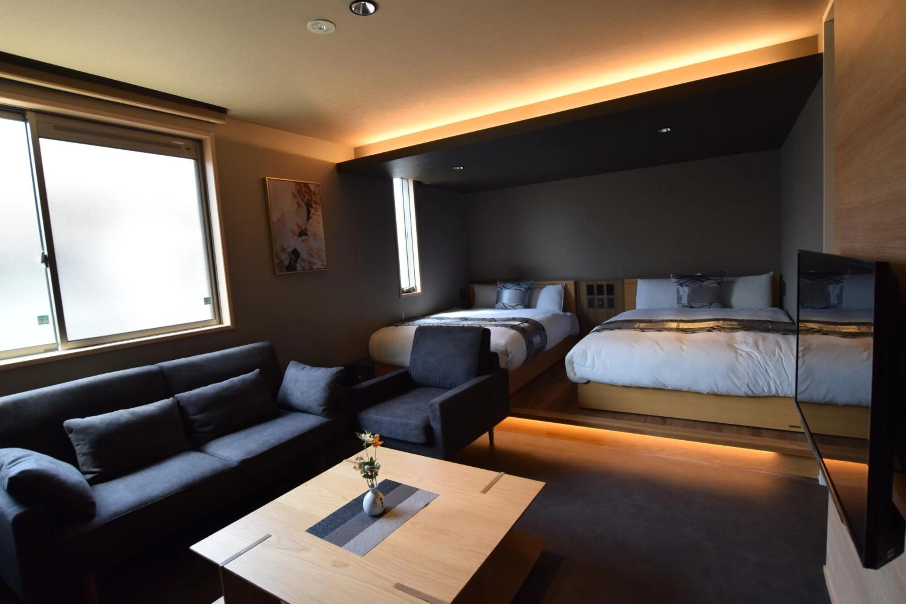 Photo of the whole room, Bed in GRAND BASE Beppu Ekimae