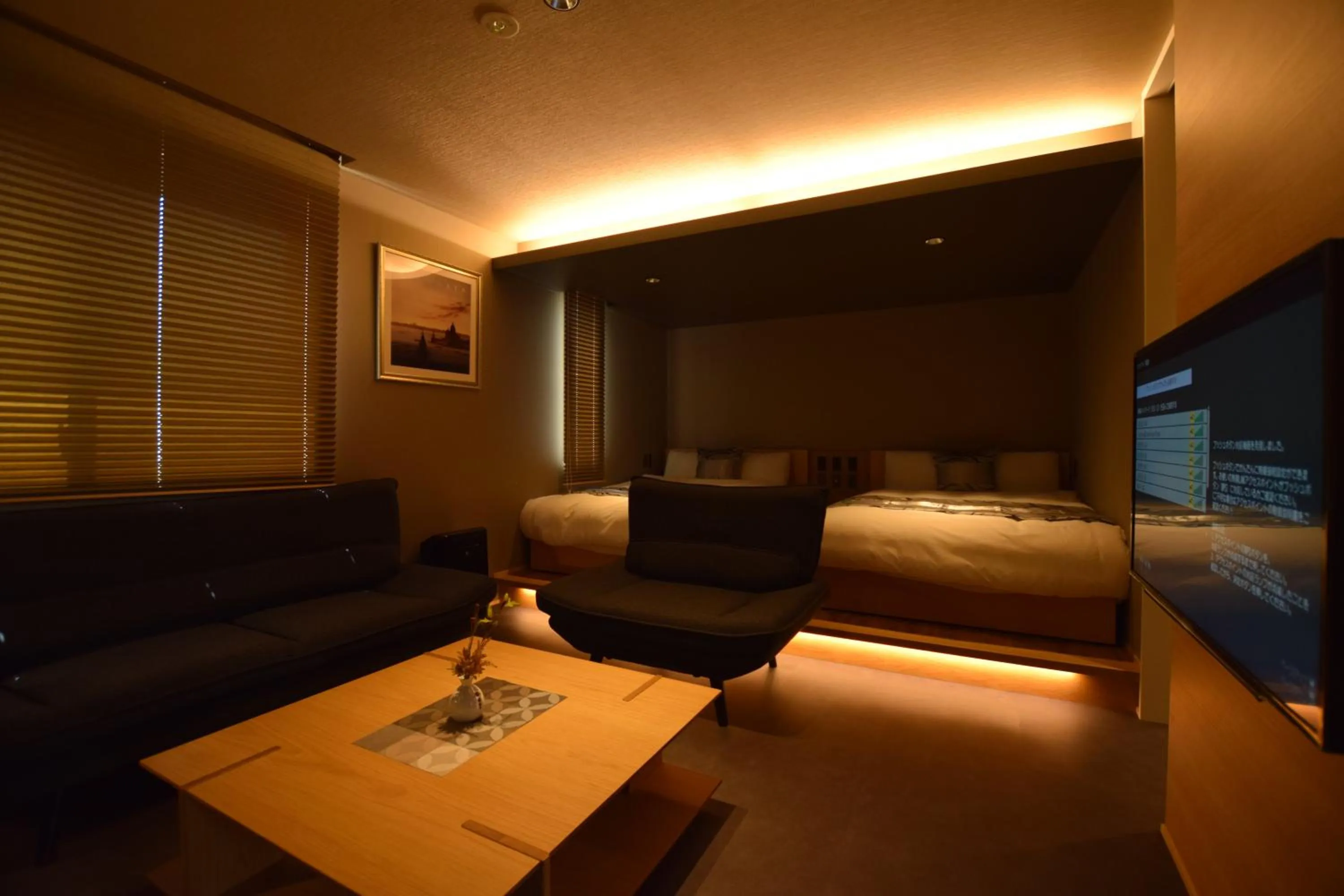 Photo of the whole room, Bed in GRAND BASE Beppu Ekimae