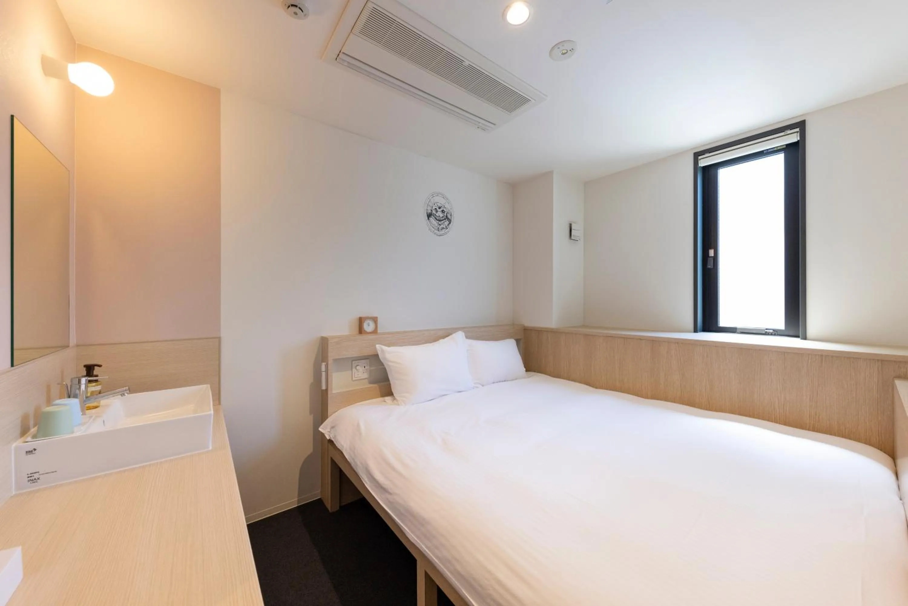 Photo of the whole room, Bed in WeBase Hiroshima