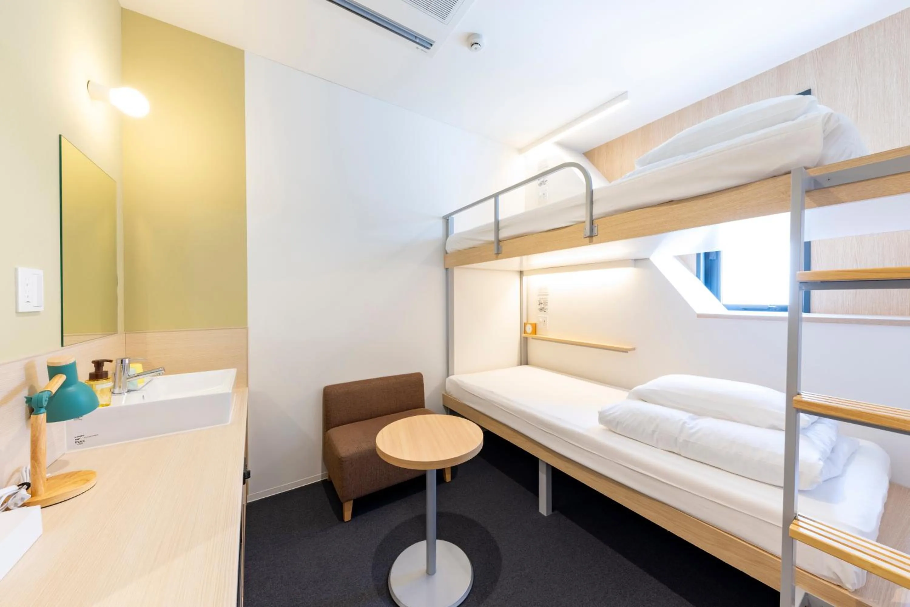 Photo of the whole room, Bed in WeBase Hiroshima