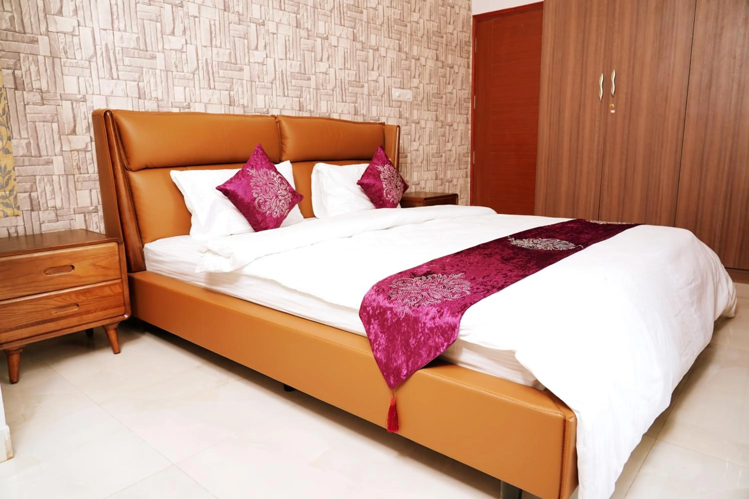 Bed in UNNATHI SUITES