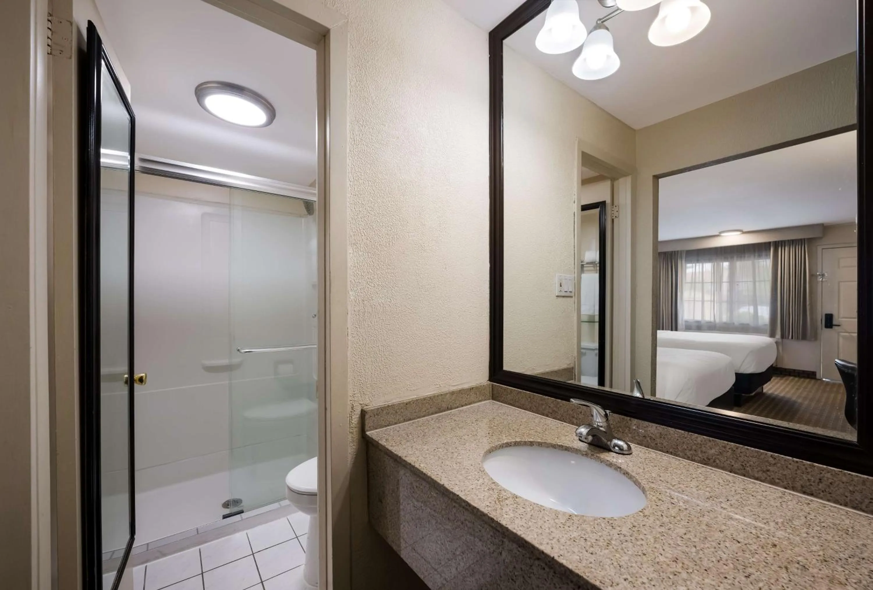Bathroom, Bed in SureStay Plus by Best Western Woodbury Inn