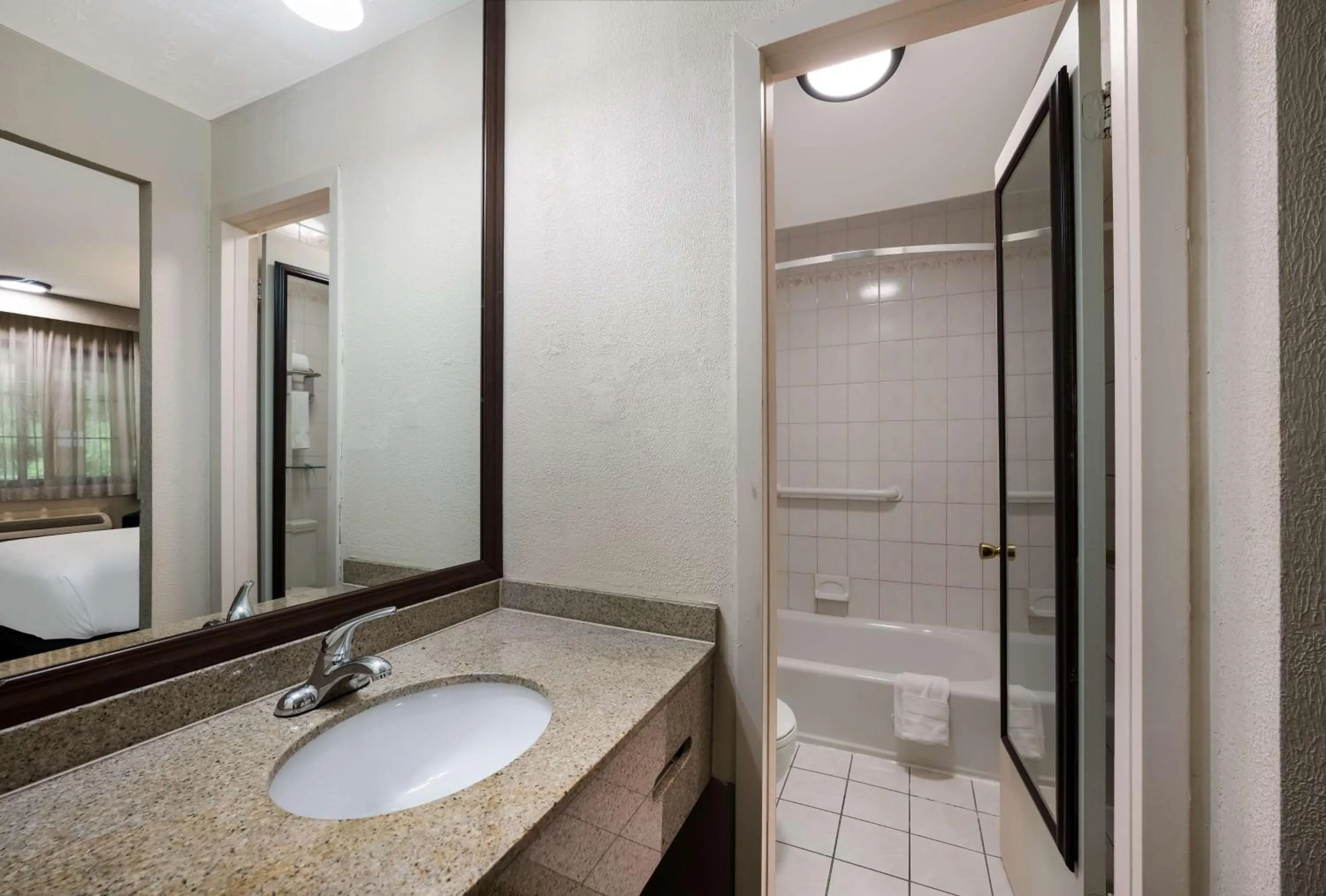 Bathroom in SureStay Plus by Best Western Woodbury Inn