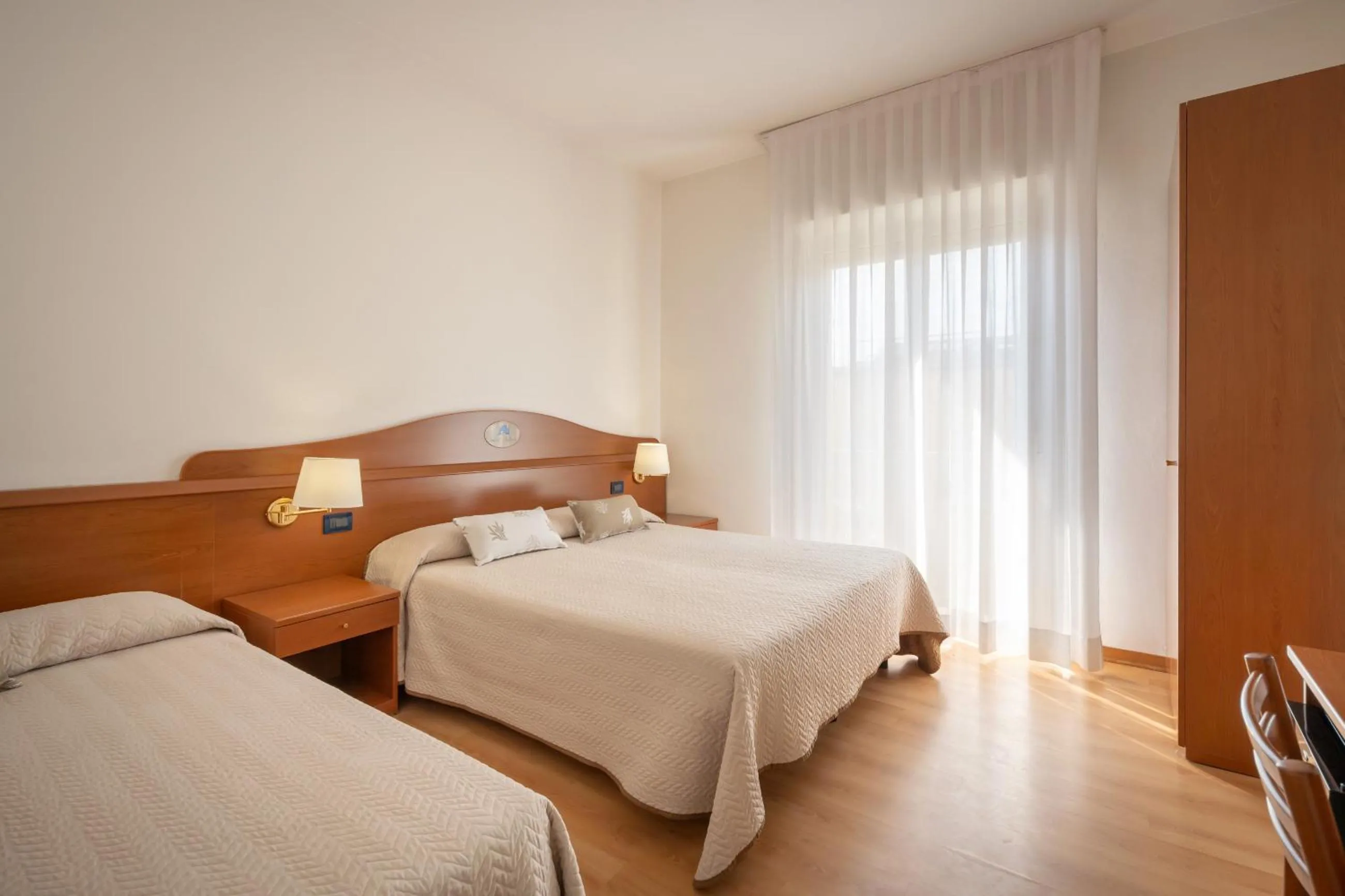 Bed in Hotel Delfino