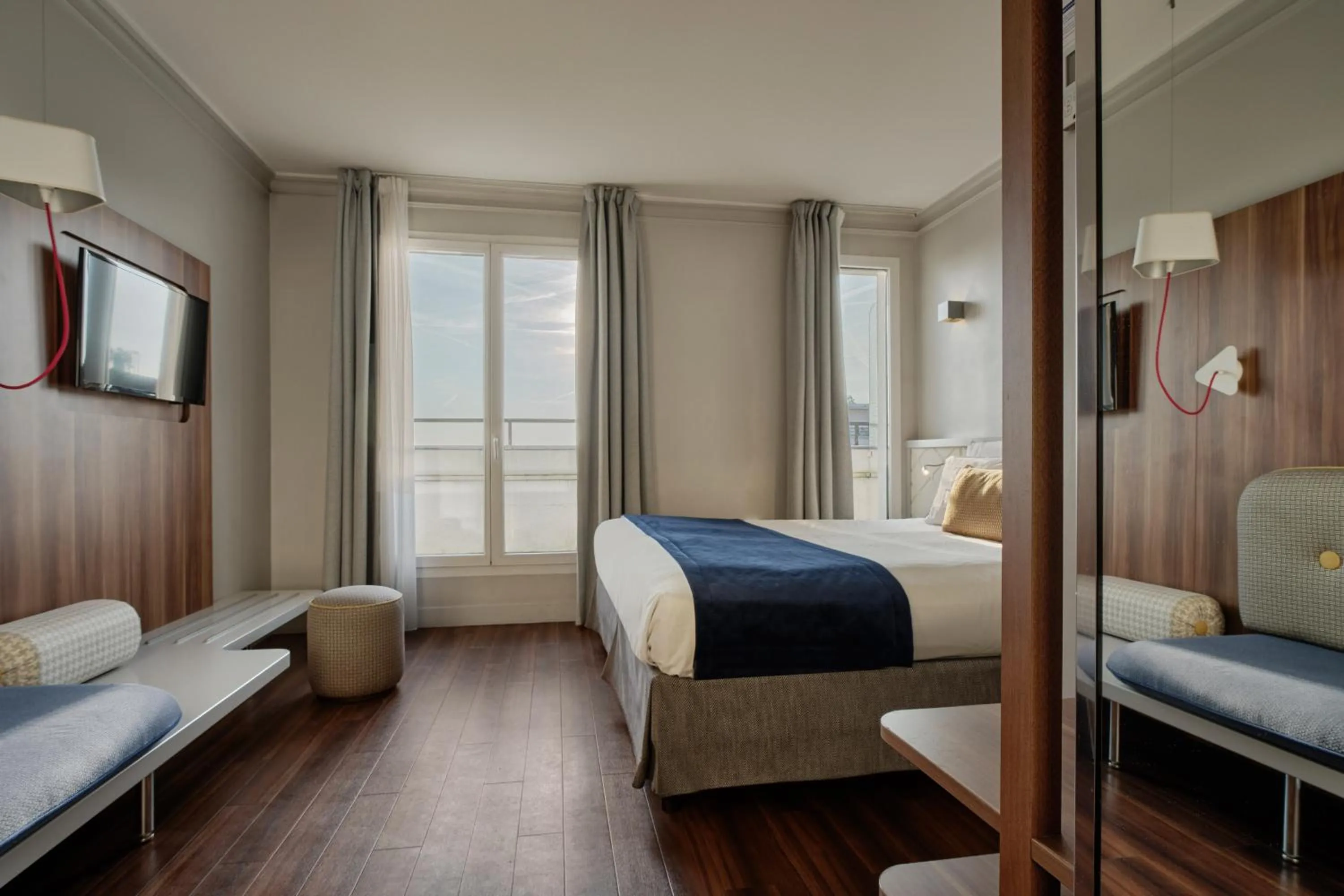 Bed in Hotel Atrium by Happyculture