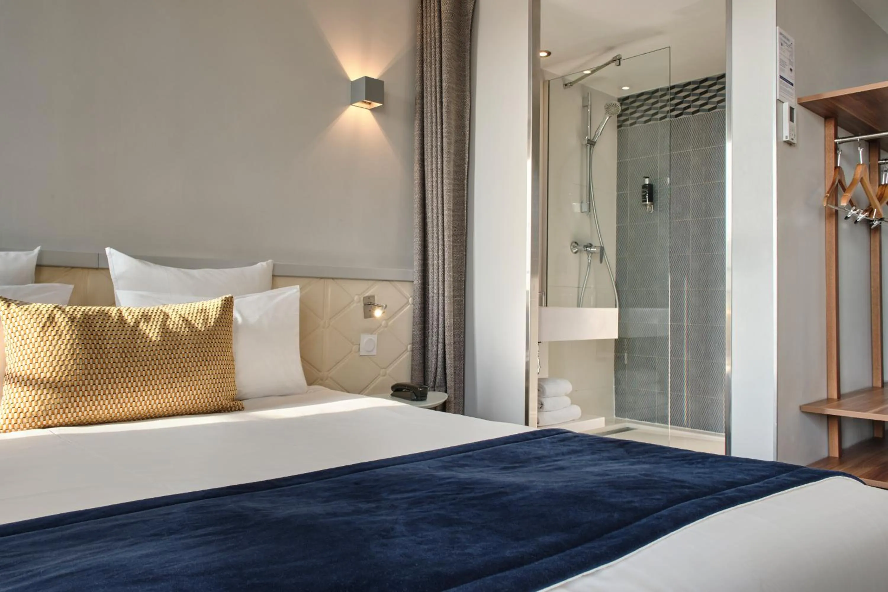 Shower, Bed in Hotel Atrium by Happyculture