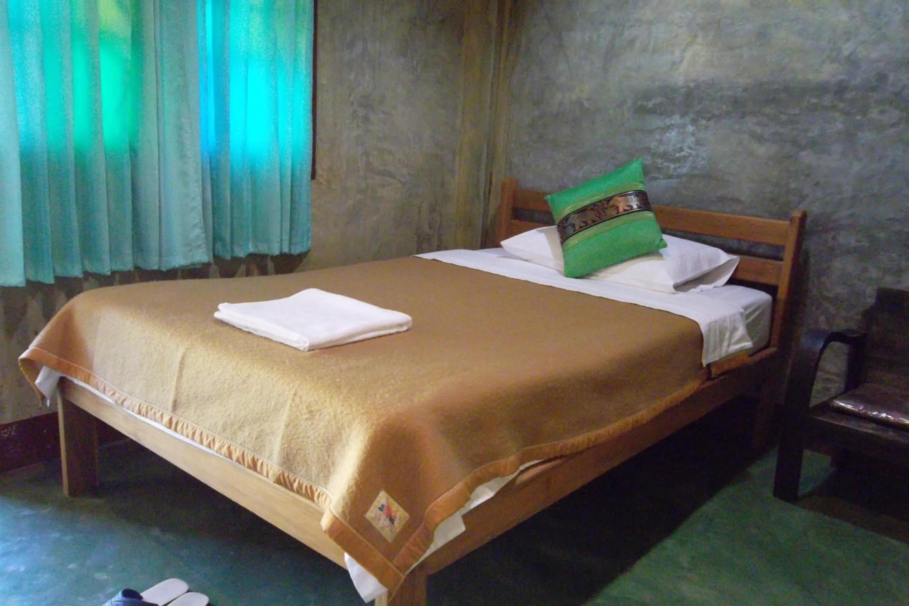 Bed in Tamarind Grand Resort Mae Sariang