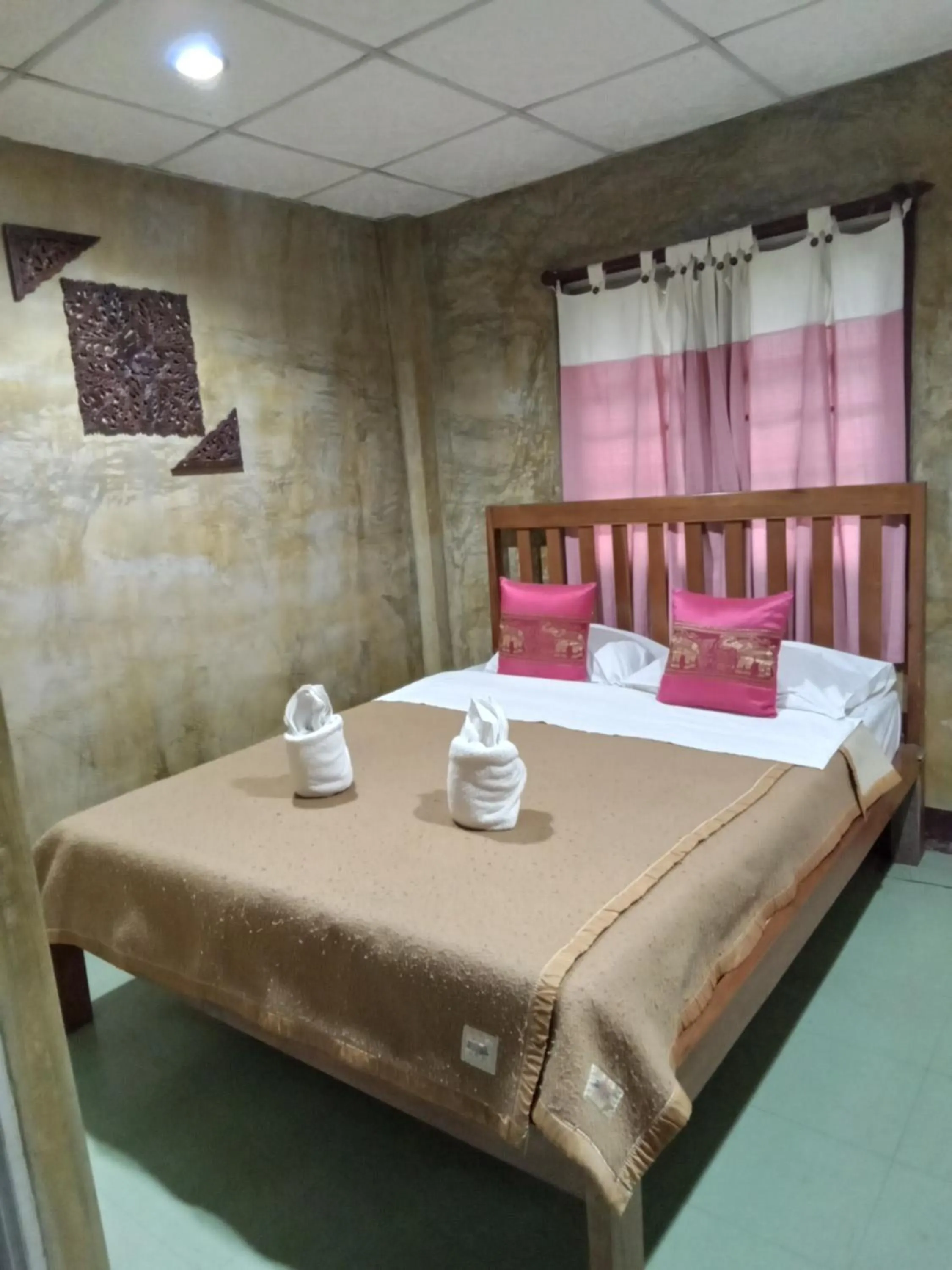 Bed in Tamarind Grand Resort Mae Sariang