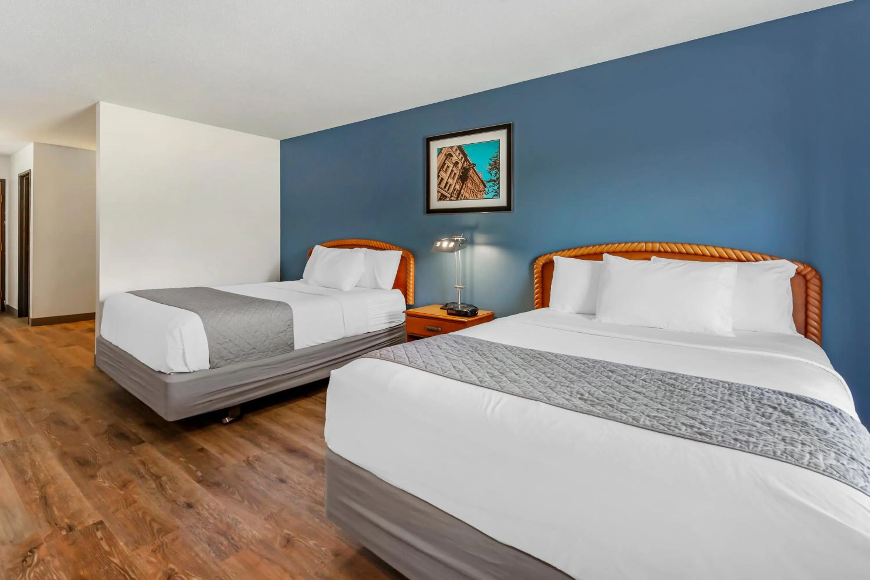 Bed in Polynesian Hotel & Suites