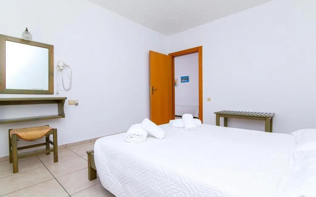 Bed in Dionysos Apartments & Studios