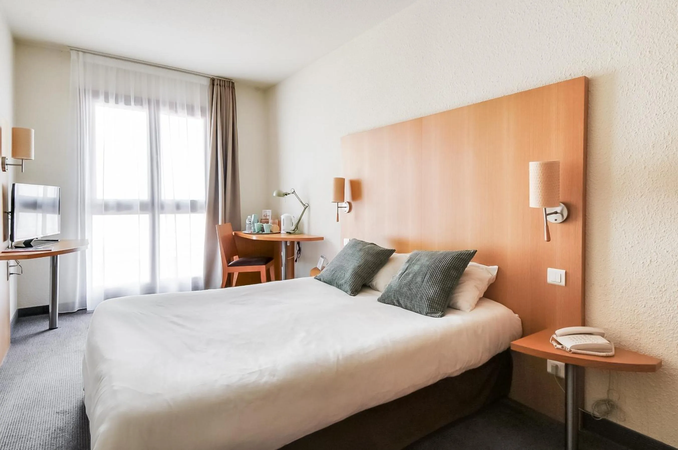 Photo of the whole room, Bed in La Maison Hôtel Mulhouse Centre