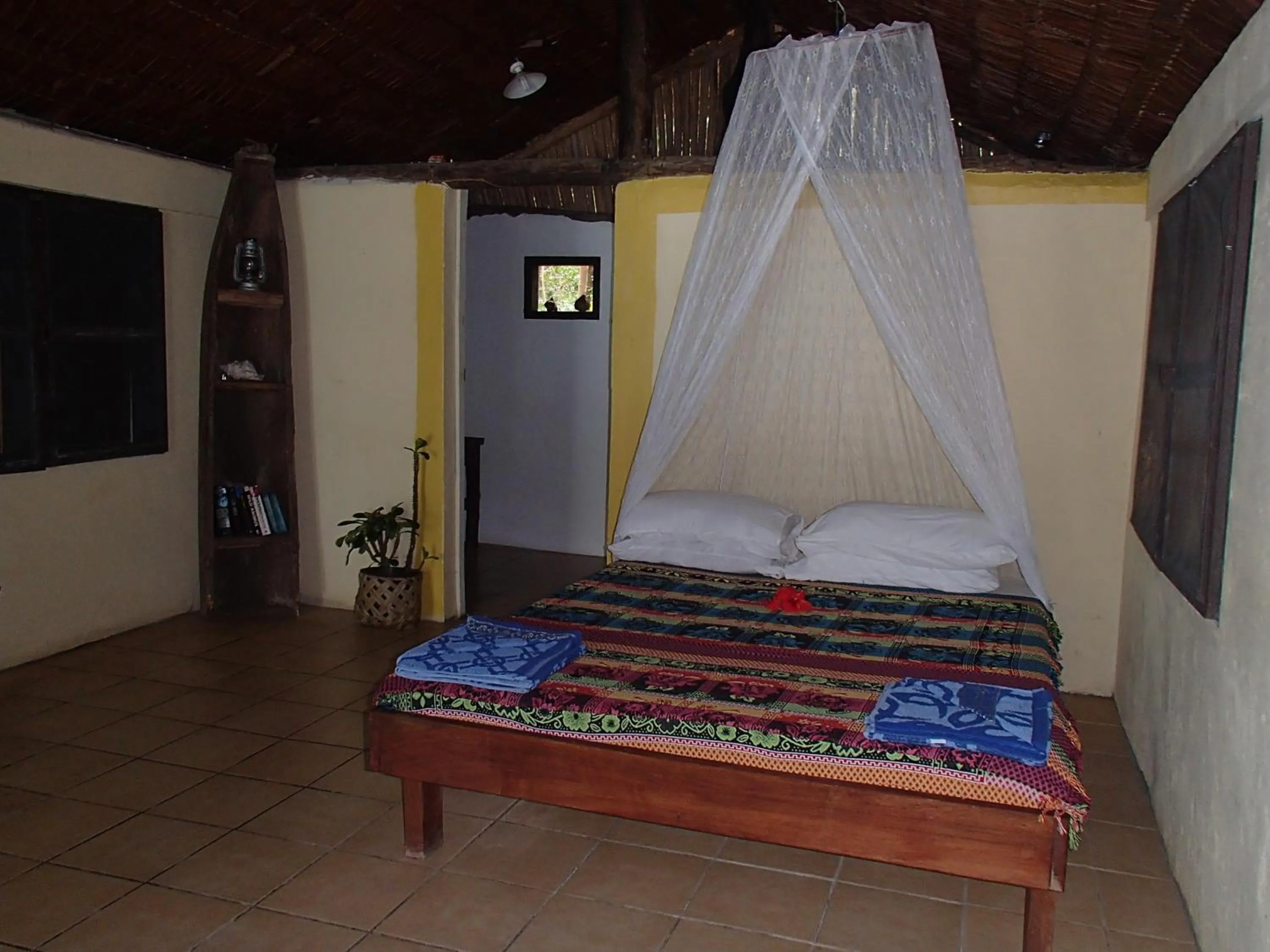 Bed in Tranquility Island Eco Dive Resort
