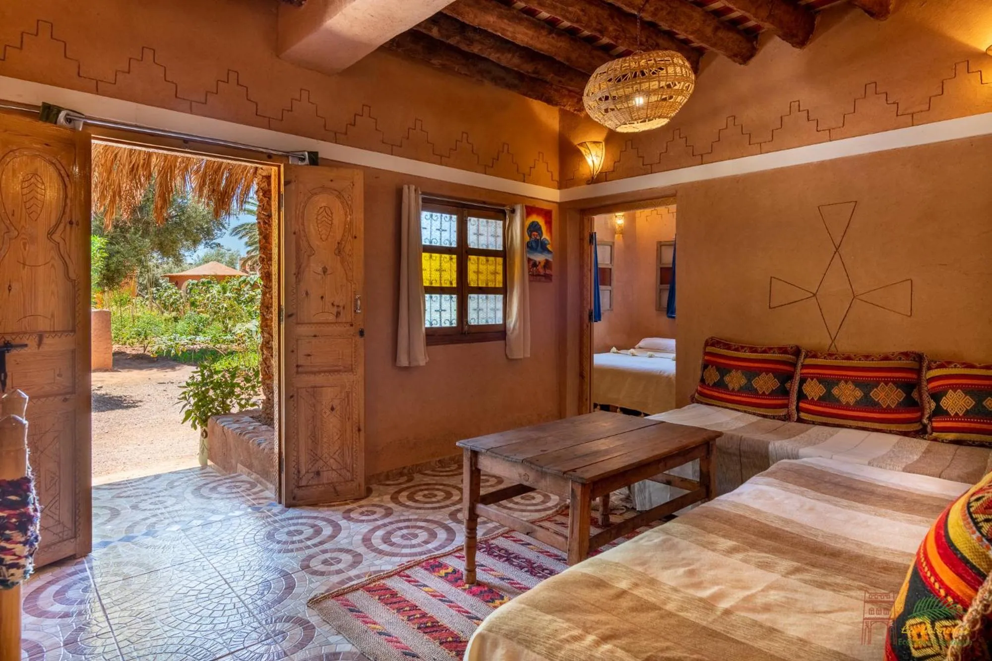 Living room, Bed in Ecolodge La Palmeraie